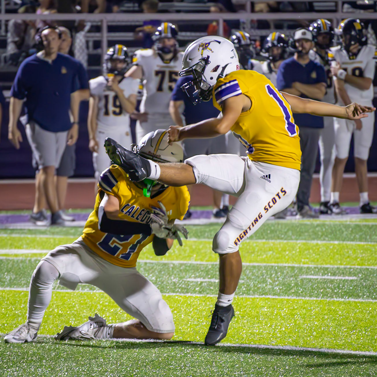 With precision and focus, Tyden Schuch sets up the ball while Landry Mueller sends it through the uprights for a successful field goal. (Photo by Taya Penoes)