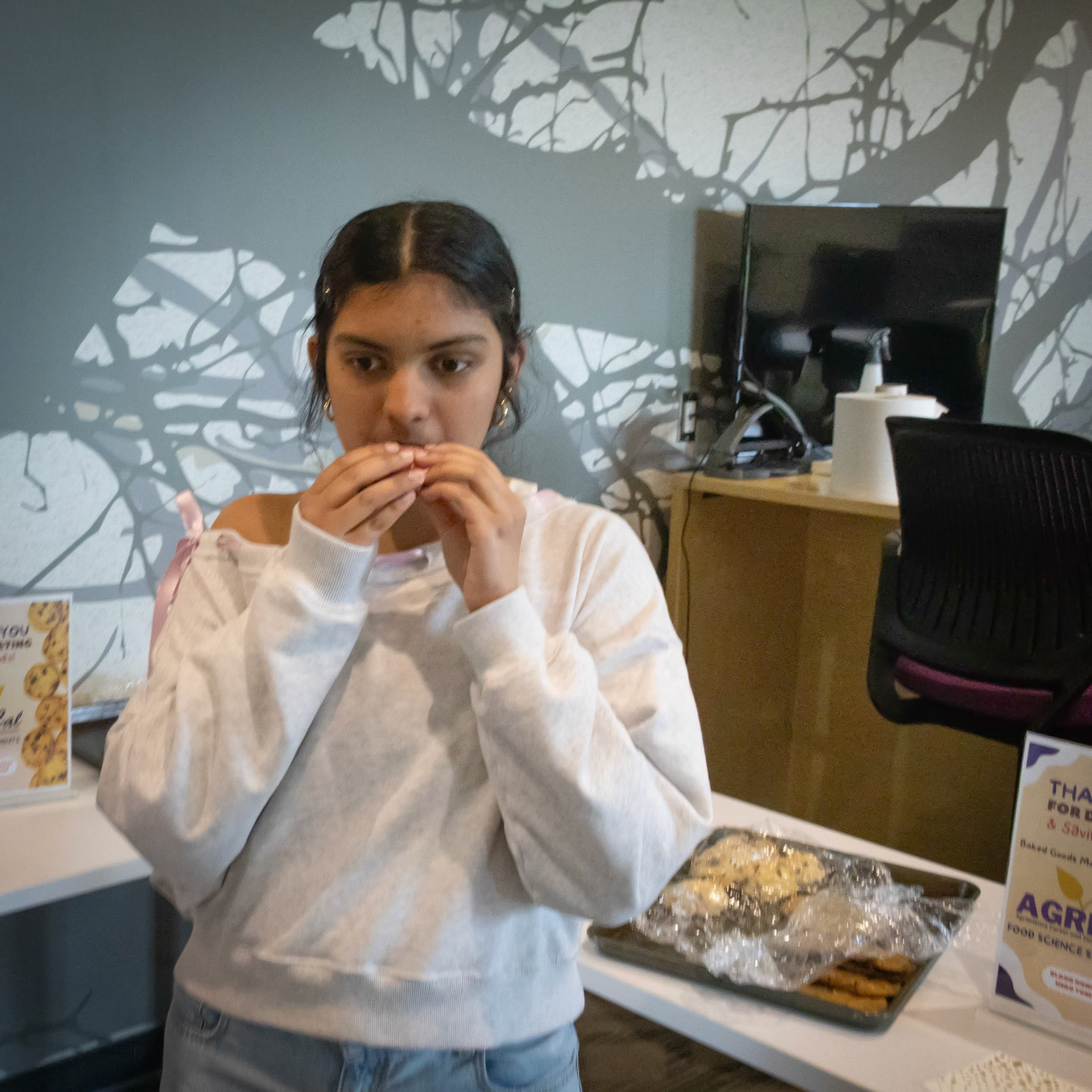 At the NHS blood drive Shrimathi Kumar samples from the tables filled with trays of cookies provided by Mrs Bender's Food Science classes. (Photo by Ella-Grace Wickens)