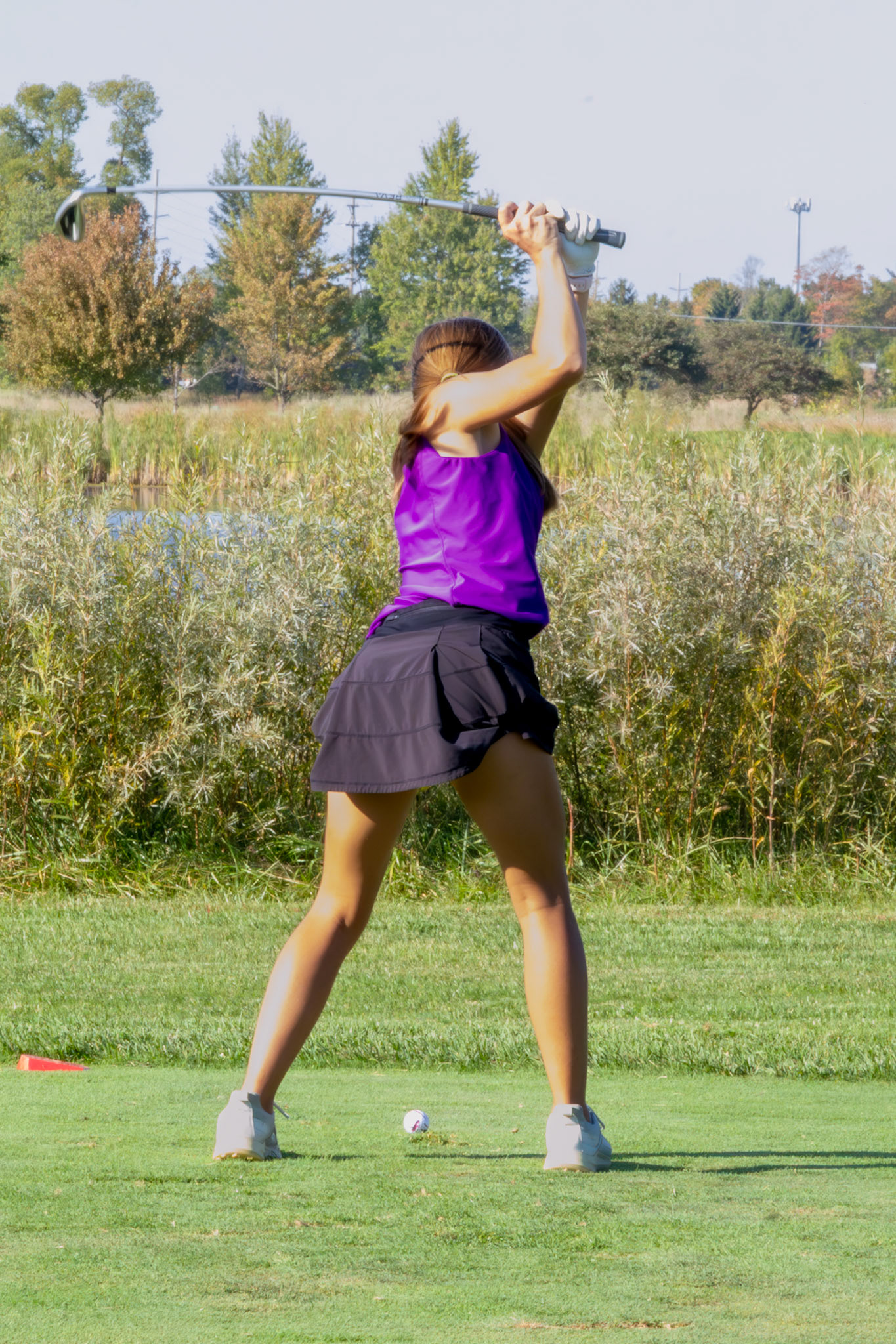 STEADY SWING Junior Lauren Scheid has a nice shot sticking the green. (Photo by Ryder Born)