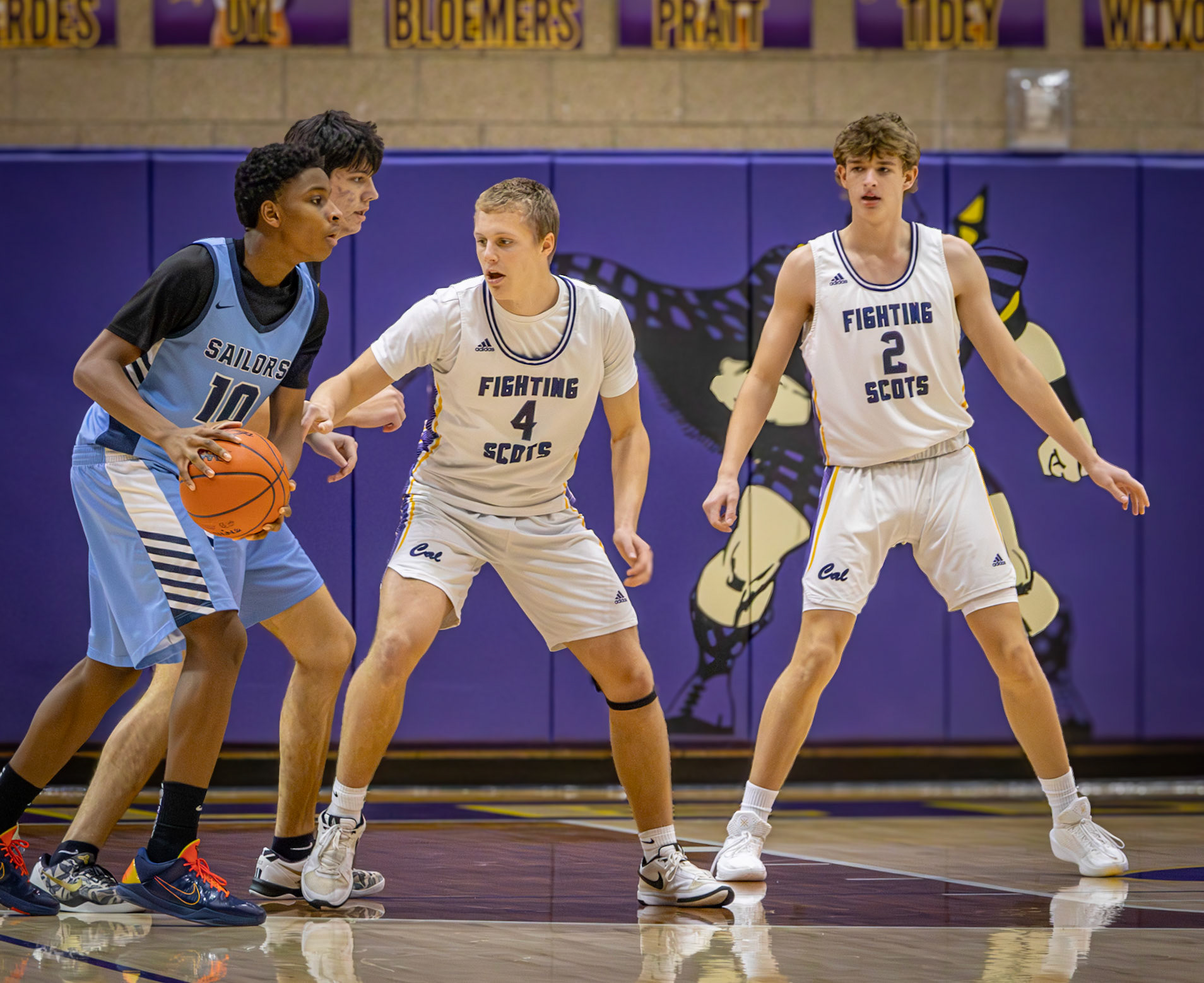 Focused on guarding the ball, Logan Uyl shows his togetherness with the team during a key defensive play. (Photo by Landry Mueller)