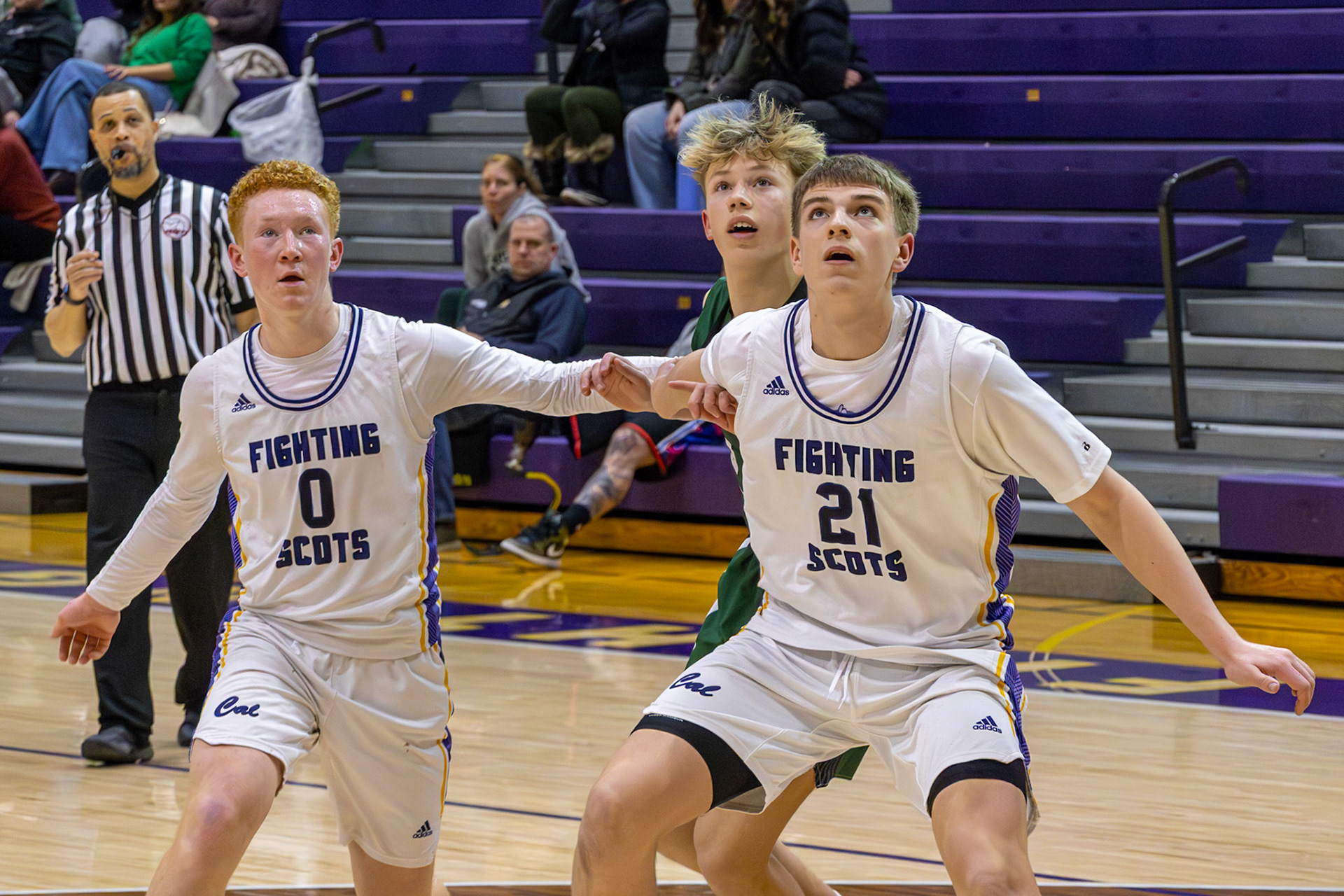 Sutton Smith and Owen Bloemers box out their opponent while tracking the ball for an easy rebound. (Photo by Thomas Fryers, Jr.)