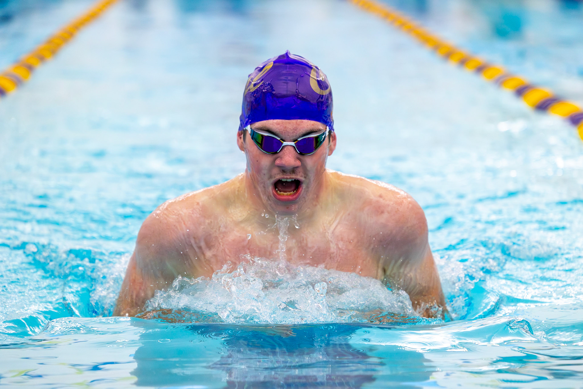 Andrew Barnum competes in the 100-yard breaststroke, digging in during the closing length. (Photo by Hailey Thayer)