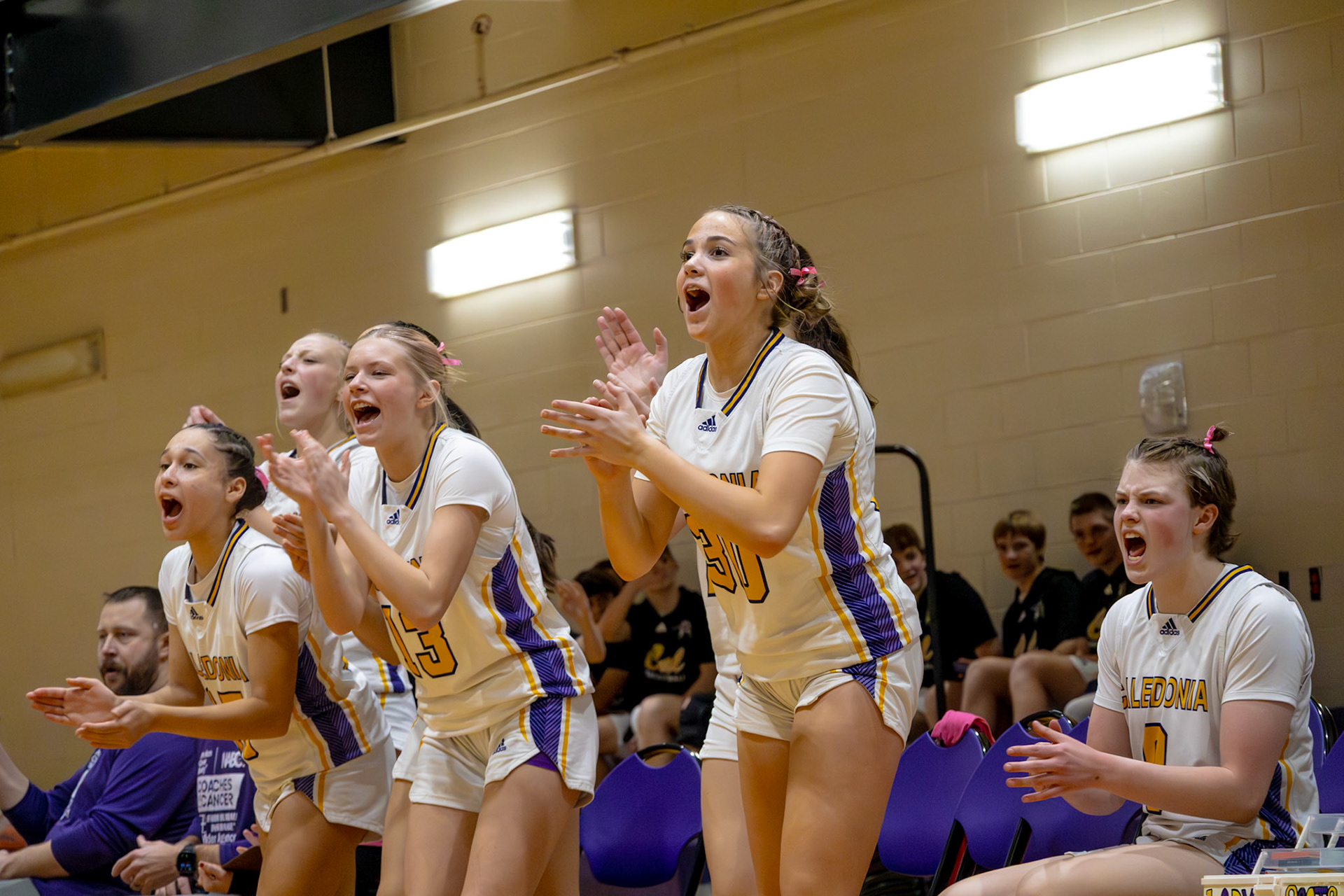 The Caledonia JV girls bench cheers for their team after a layup. (Photo by Abigail Douglass)