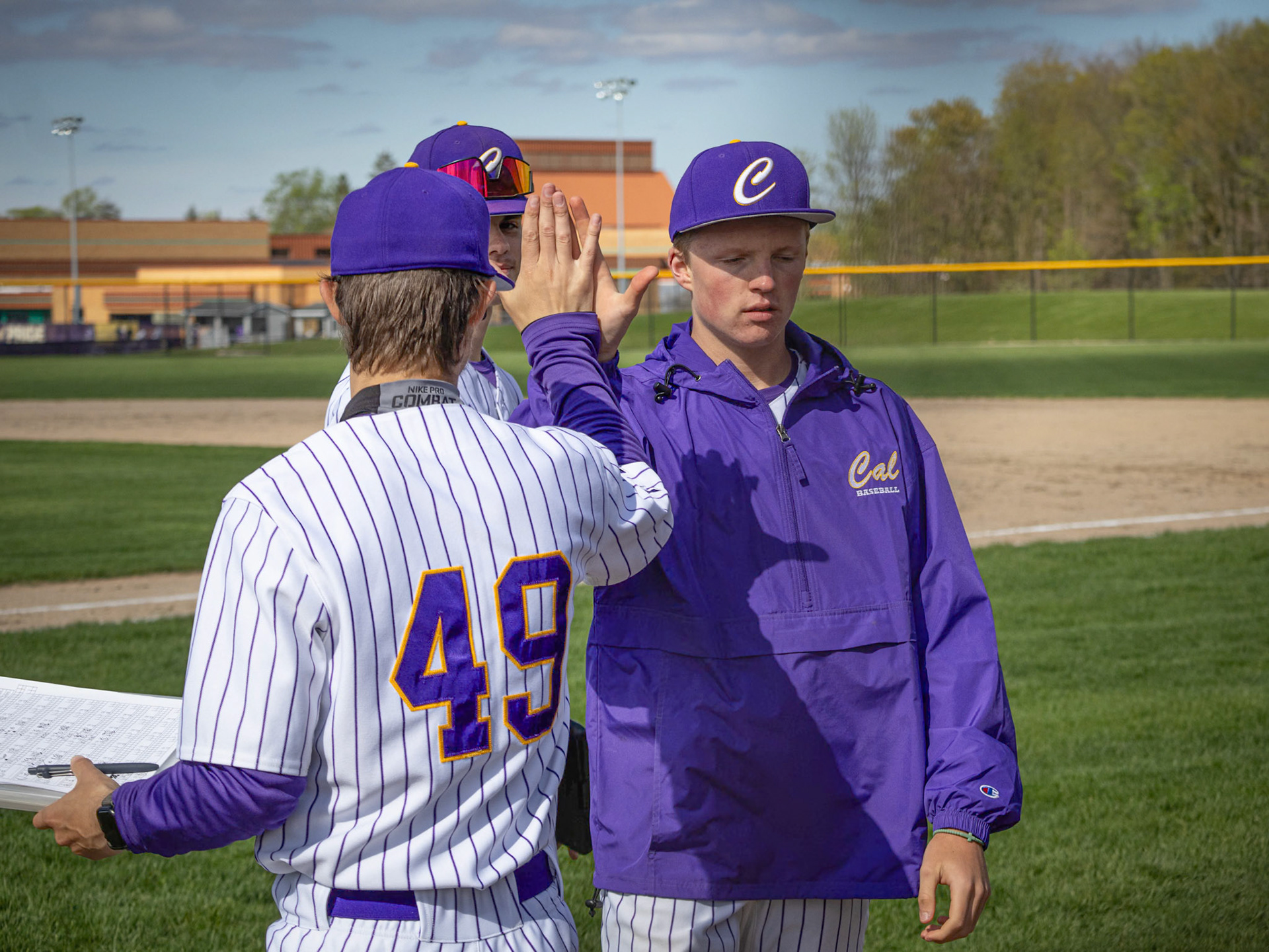 Despite an injury, James Abbott recieves a high five from Coach Hutson for helping out during the game. (Photo by Ella-Grace Wickens)