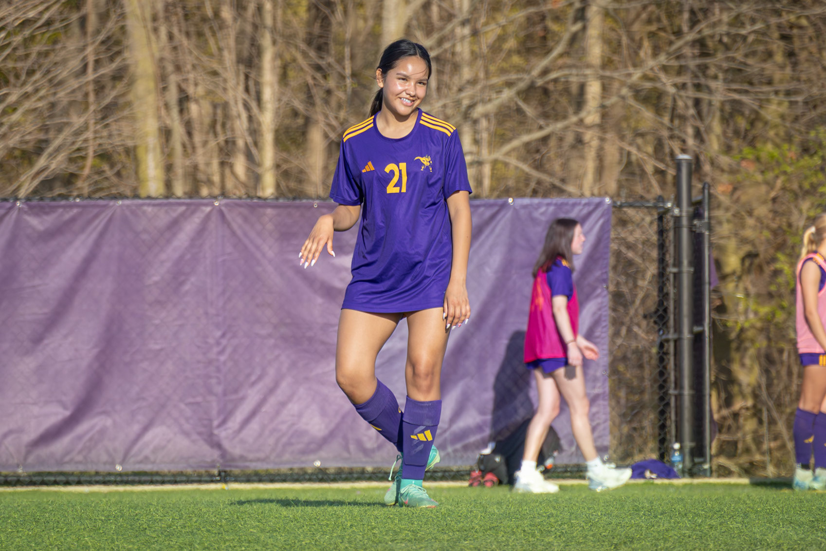 Jazmyn Thompson smiles at her teammates on the field. (Photo by Ava LaBine)