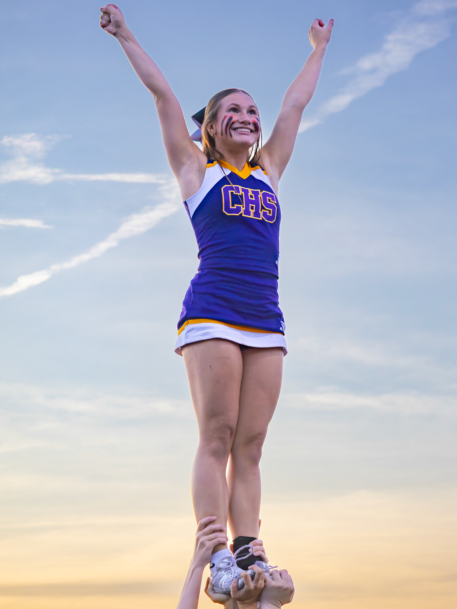 Arms up and full of spirit, Mariah Peterson leads with confidence and school pride to cheer on Caledonia agaisnt Hudsonville. (Photo by Lillian Jackson)