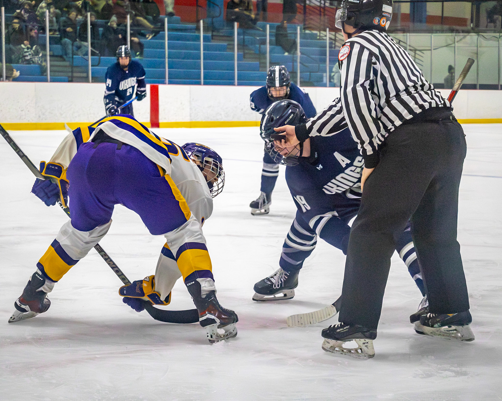 Preparing for his face off Ethan Sova keeps his eye on the puck as it slows fall to the ice and fights for the win. (Photo by Ella-Grace Wickens)