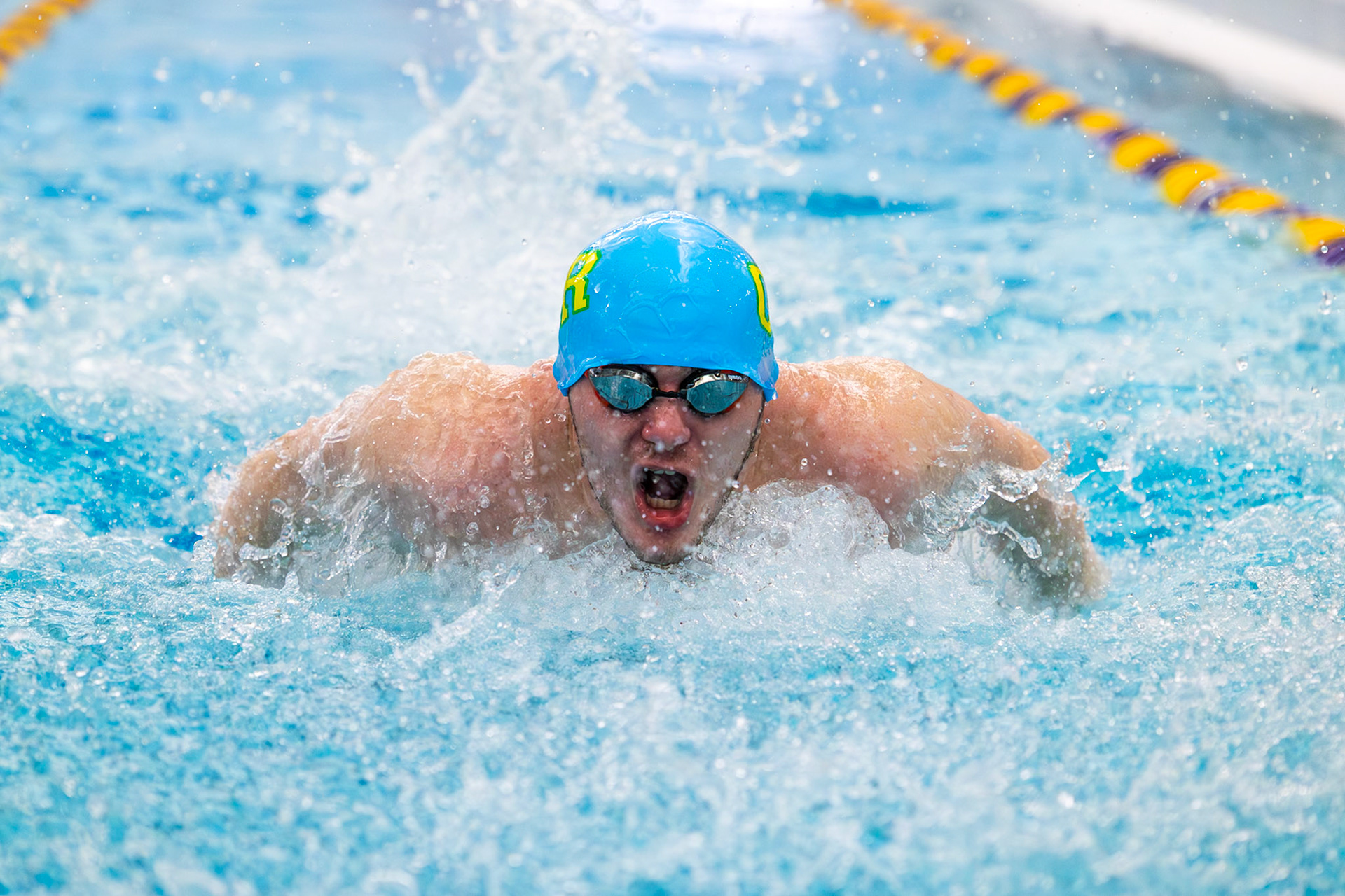 Nolan Fitzgerald swims the 100-yard butterfly, powering through each length as the race progresses. (Photo by Hailey Thayer)
