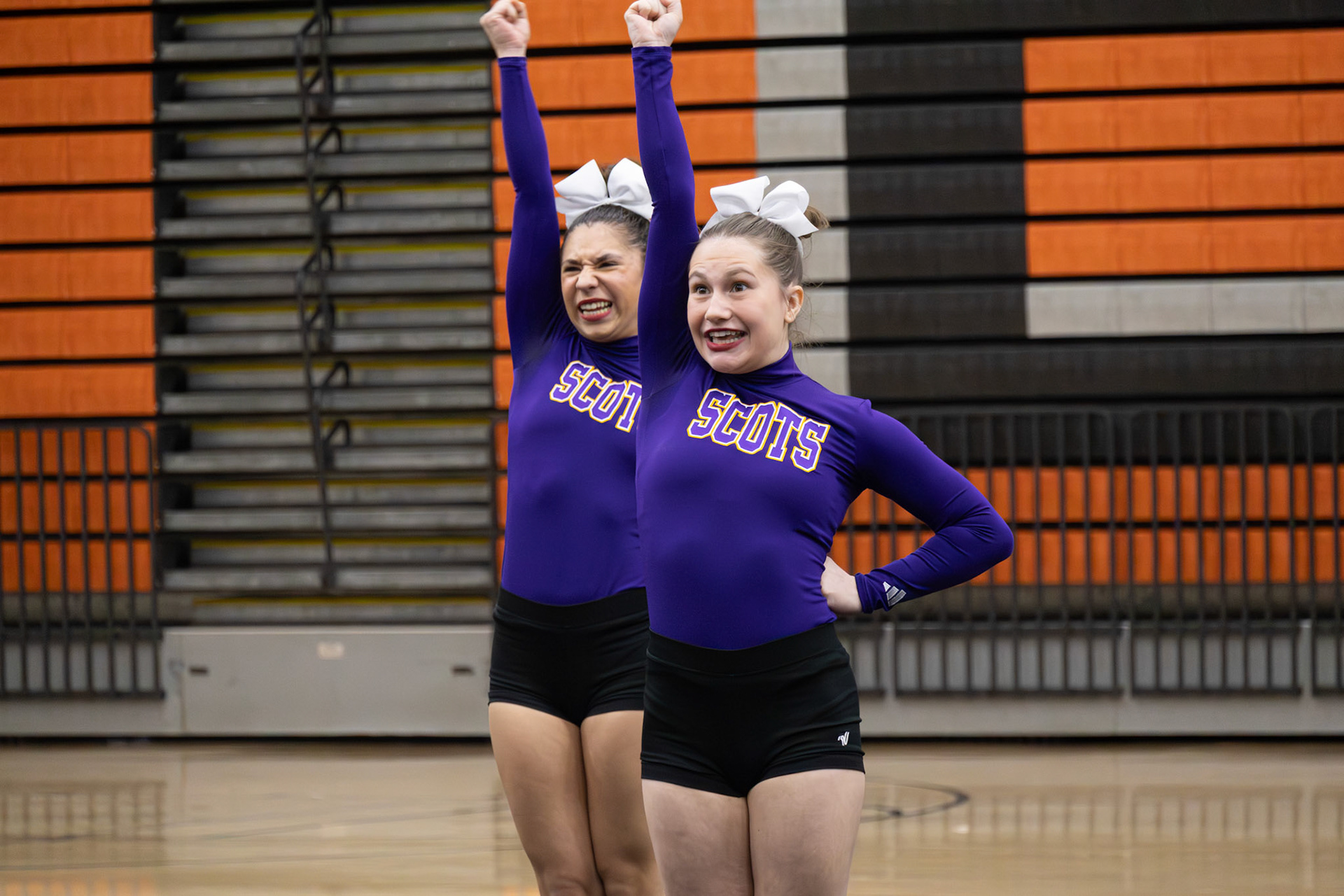 Mariah Peterson and Reagan Stevens give it their all during the “Right Fight” motion in competitive cheer, showcasing their teamwork. (Photo by Brianna Severson)