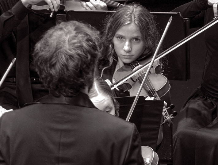 Cora Draft performs under the direction of orchestra director Mr. Liker. (Photo by Valentina Sosa)