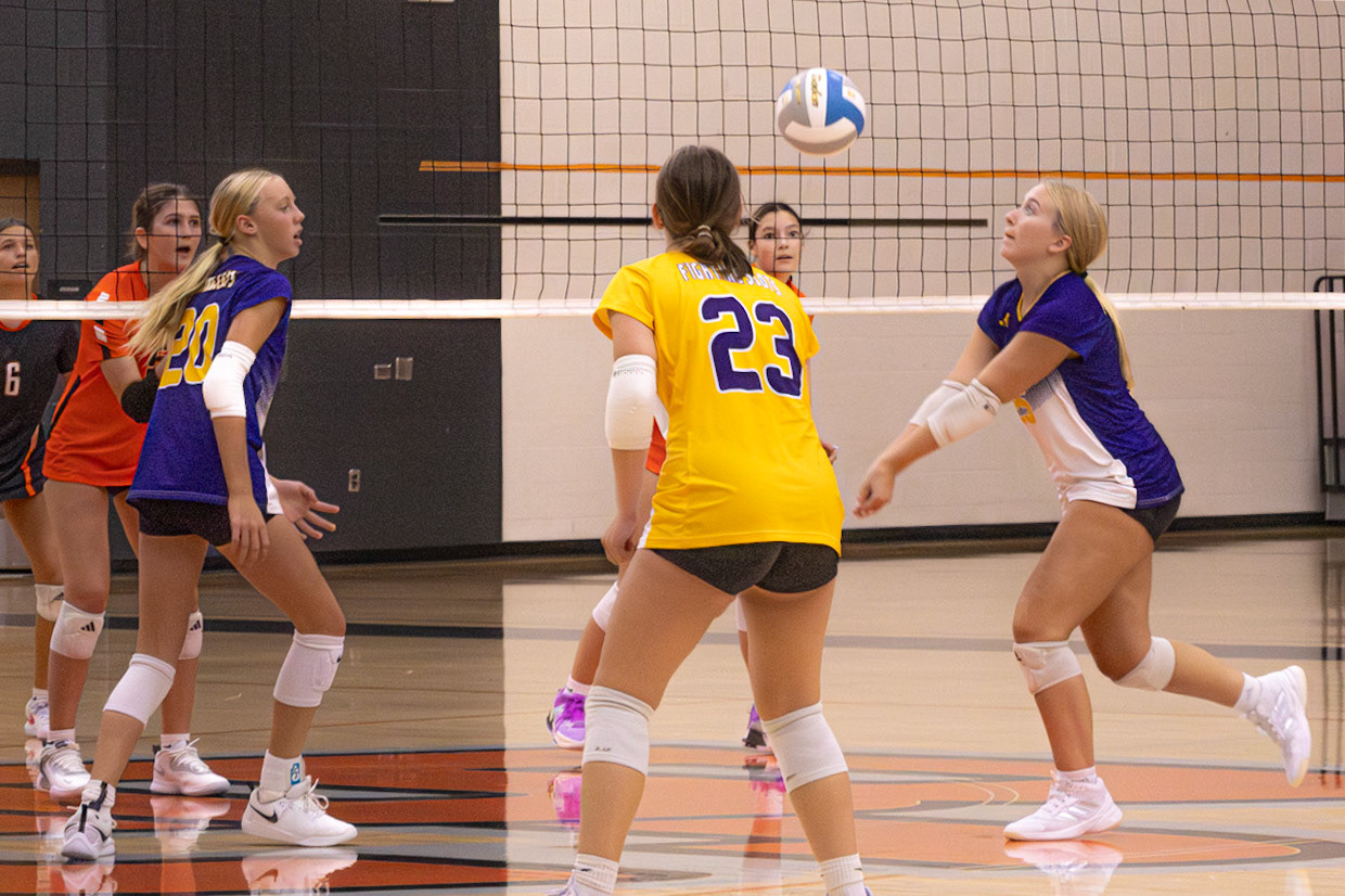 Cal and Byron Center face off at the net as a Cal player prepares to send the ball back over during a tight point. (Photo by Elsha Bytwork)