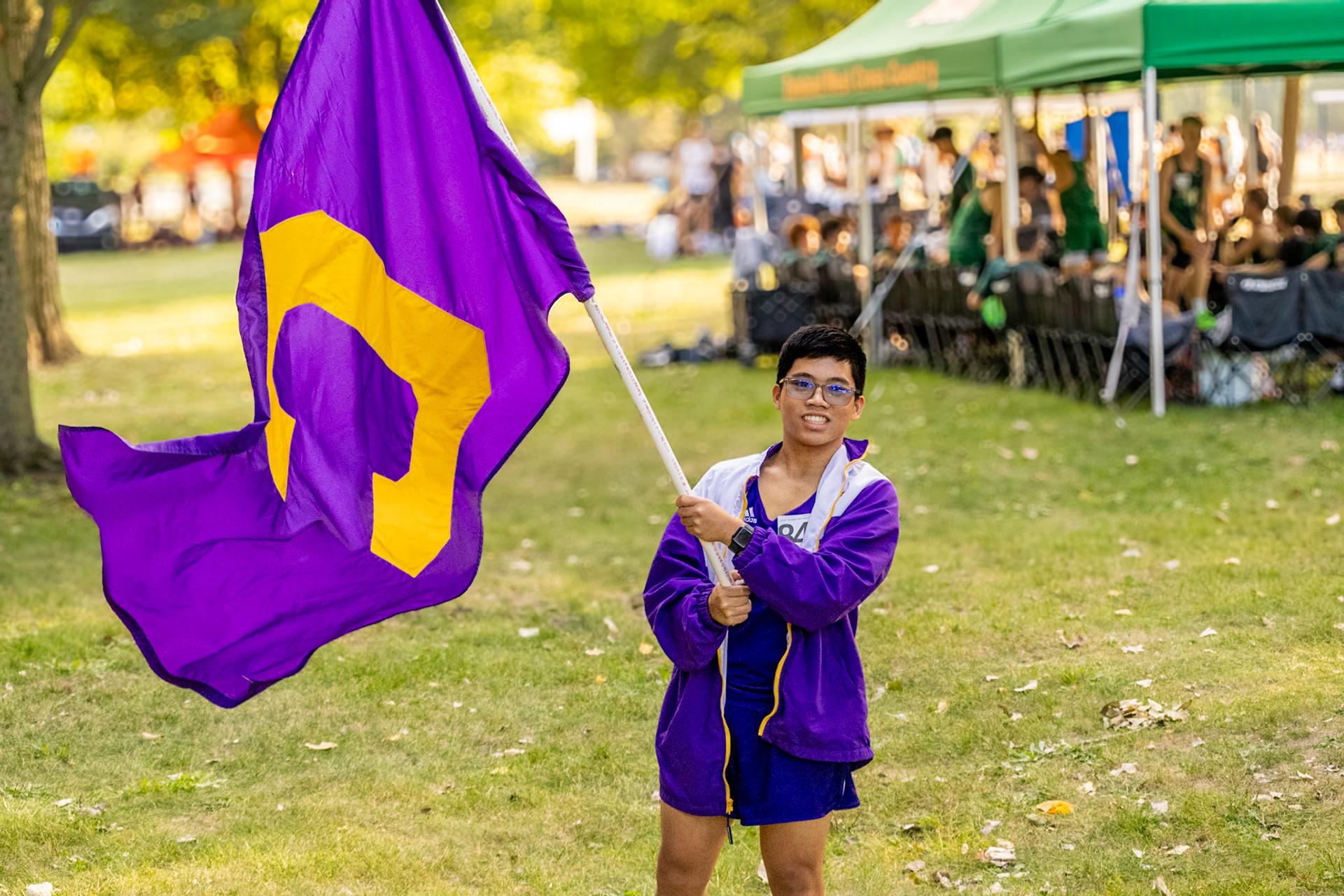 Ben Lusaya waves a flag to motivate the team. “Focus on the finish line; every mile is simply another marker pushing you forward.” (Photo by Justin Harper)
