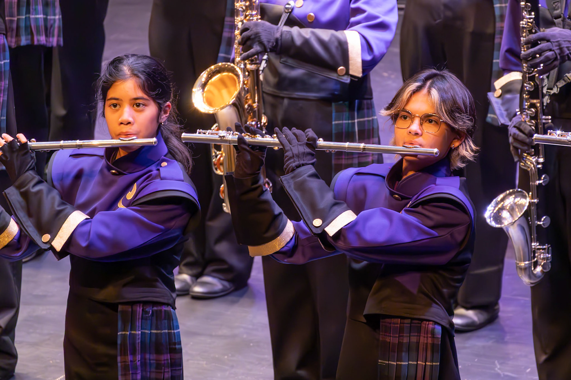 Senior Haley Harnett and sophomore Nina Lusaya focus on their flutes. (Photo by Molly Larson)