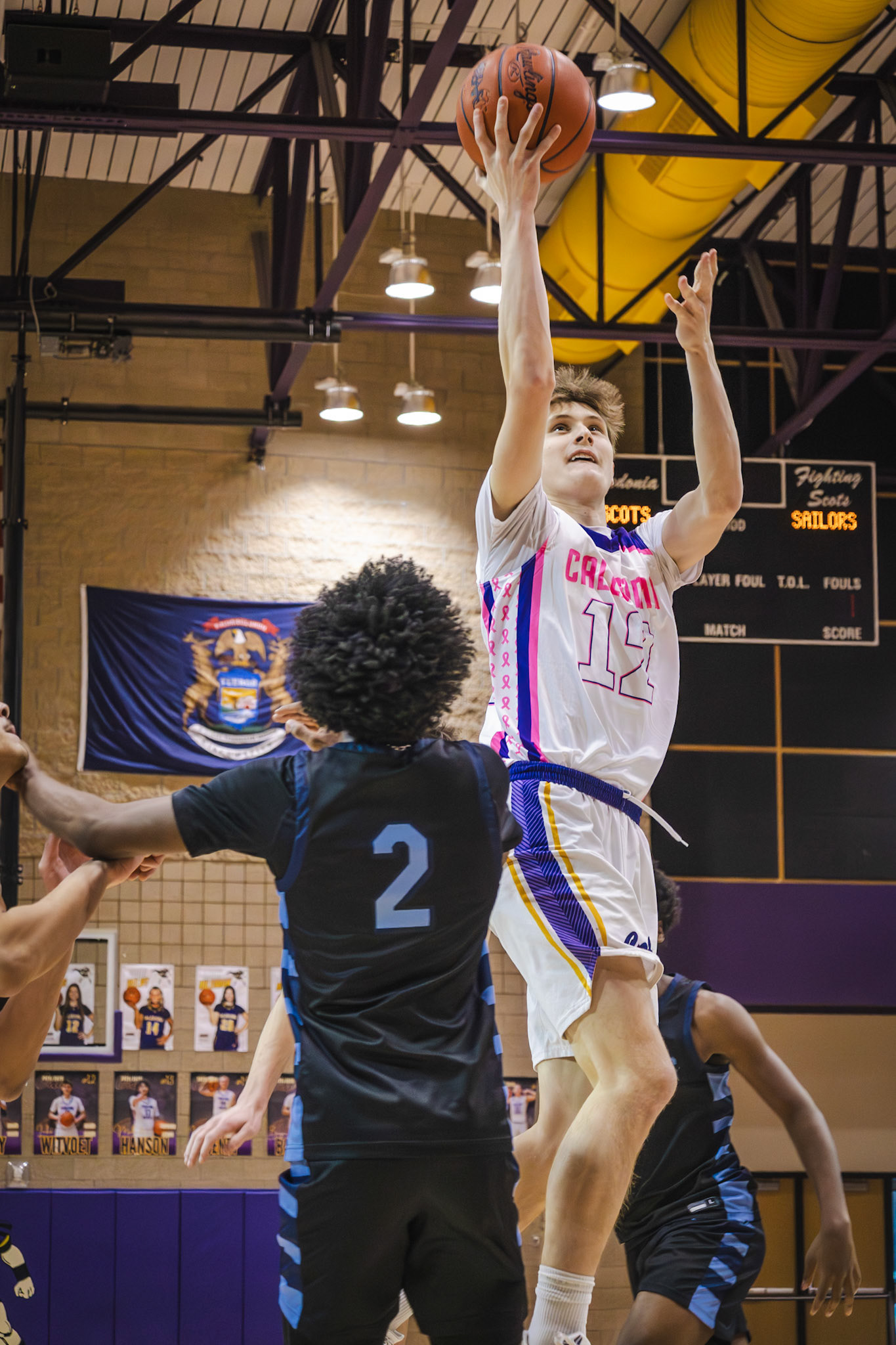 Luke Witvoet weaves through defenders for the layup. (Photo by Aaron Pyper)