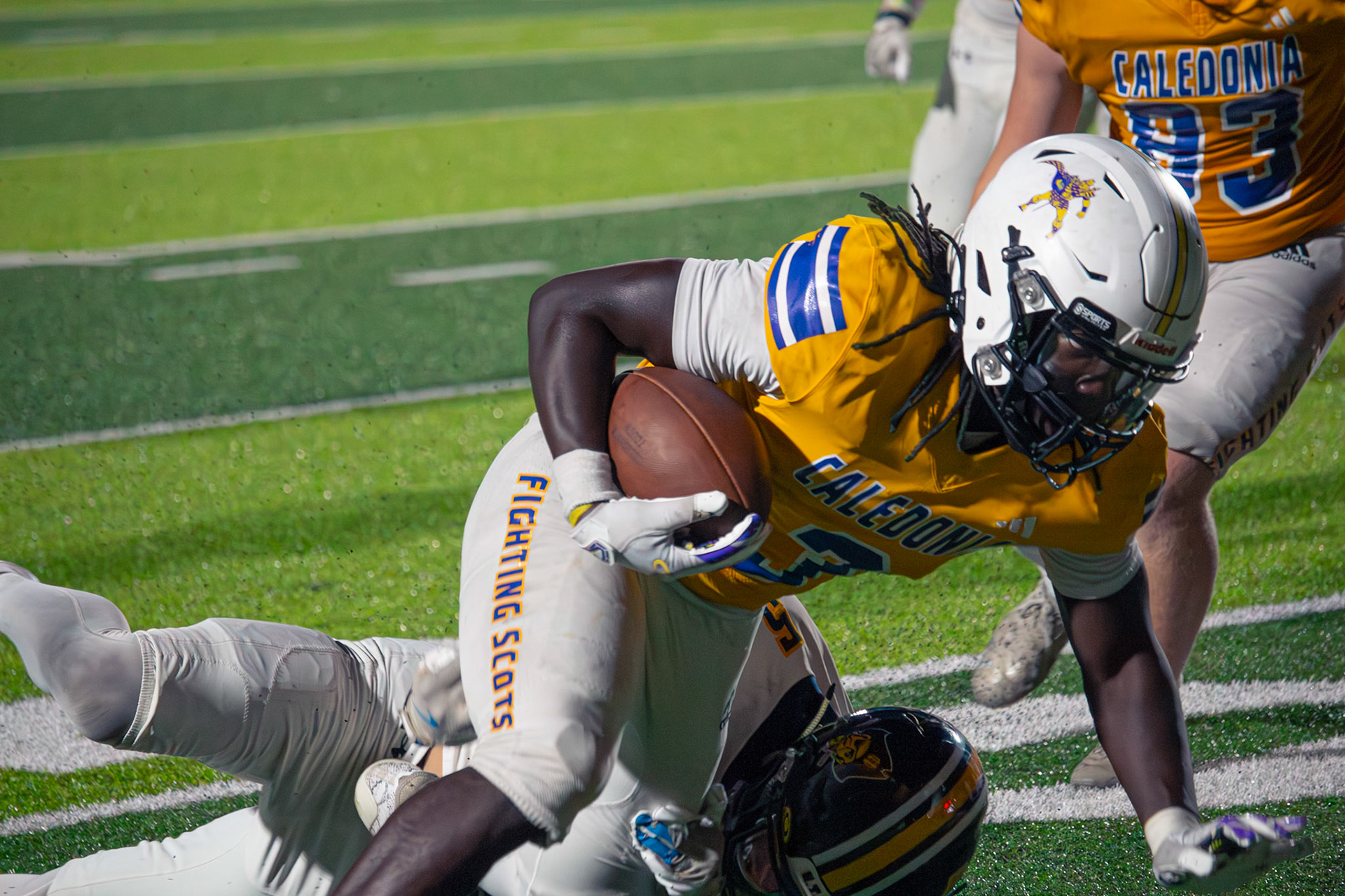Capree’ Thomas fights for yardage while tackled during the game.(Photo by Egan Otto)