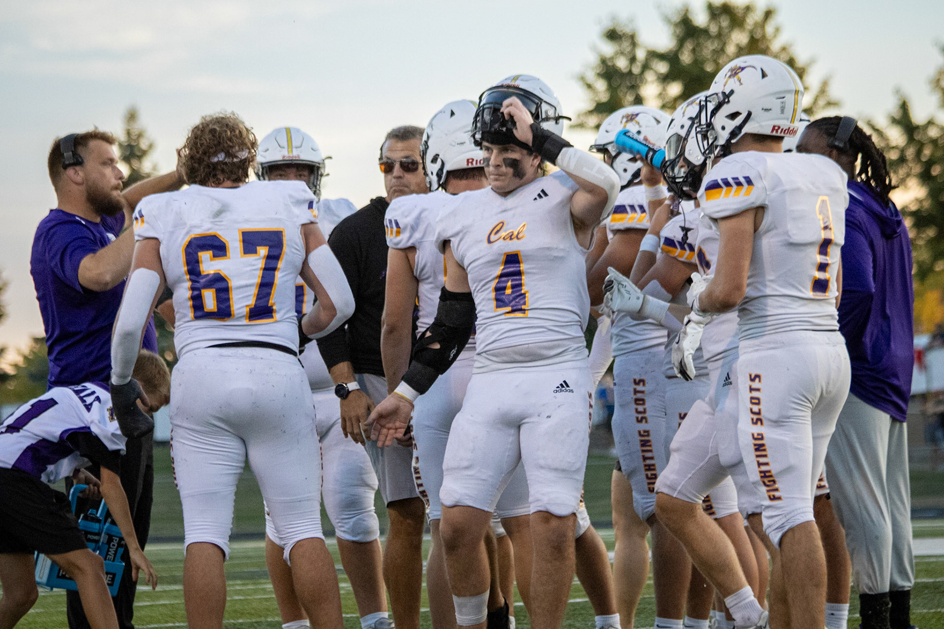 During a timeout, the coaches circle the team up, motivating the players before they head back onto the field. (Photo by Taya Penoes)
