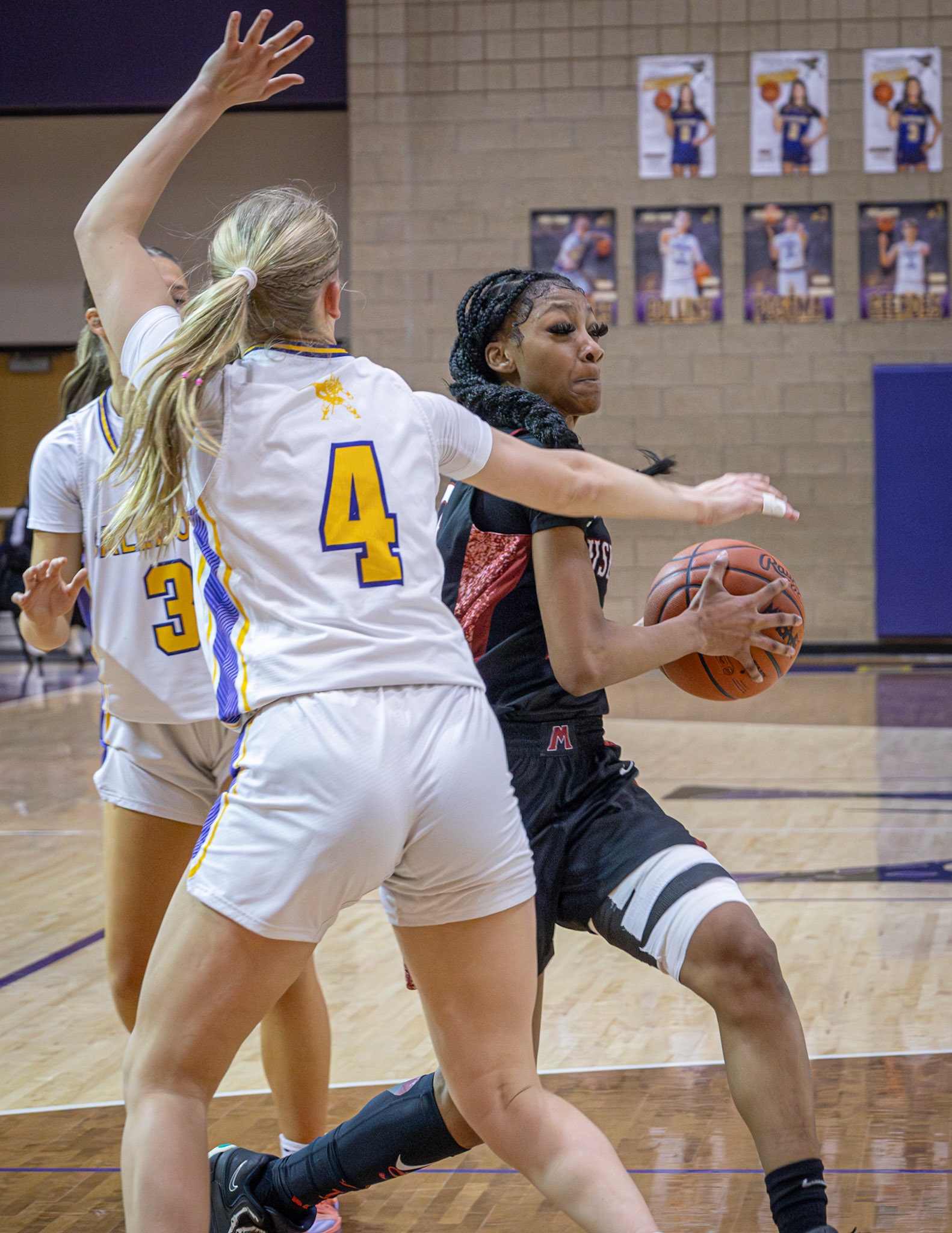 Addison Veldt applies pressure while Muskegon drives in for a layup. (Photo by Taya Penoes)