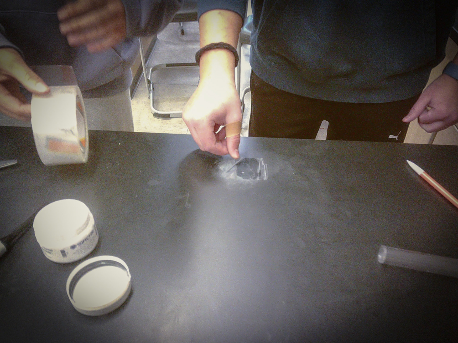 Addi Luxford peels tape up to reveal her freshly powdered fingerprint. (Photo by Keira Marshall)