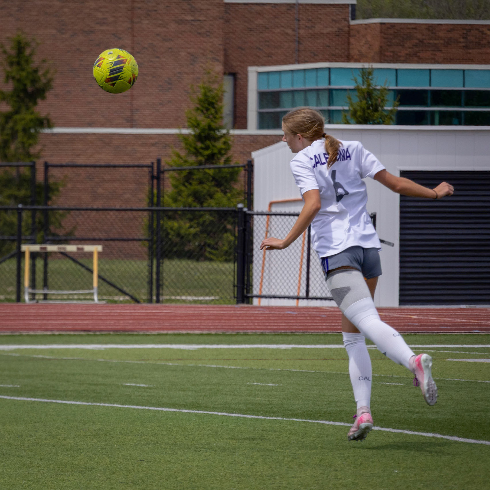 Kelsey Roszkowski heads the ball out of the air to clear it away. (Photo by Leah Hileman)