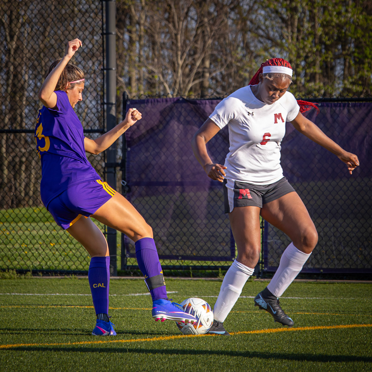 Composed, Kayla keeps control under pressure, kicking through the challenge and holding off her defender. (Photo by Aibree Akers)
