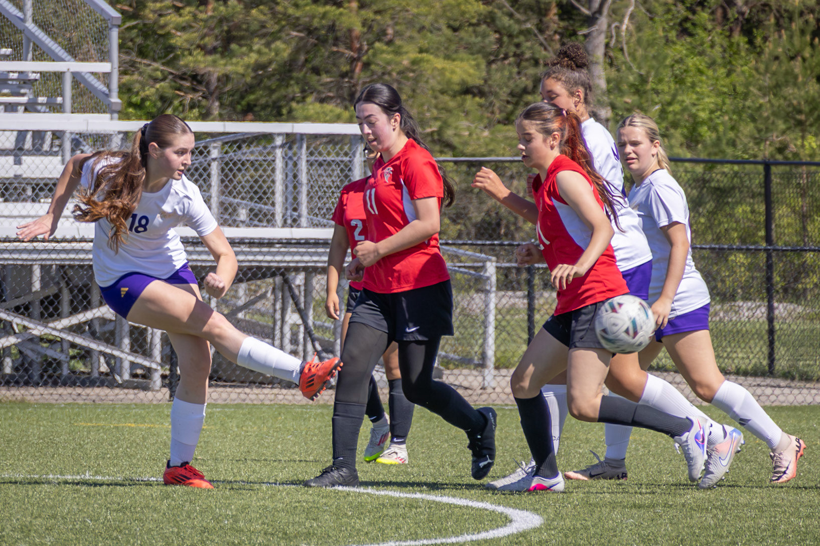 Sophomore MacKenzi Price Passes the ball past her opponents to her teammate. (Photo by Eva Sierra)