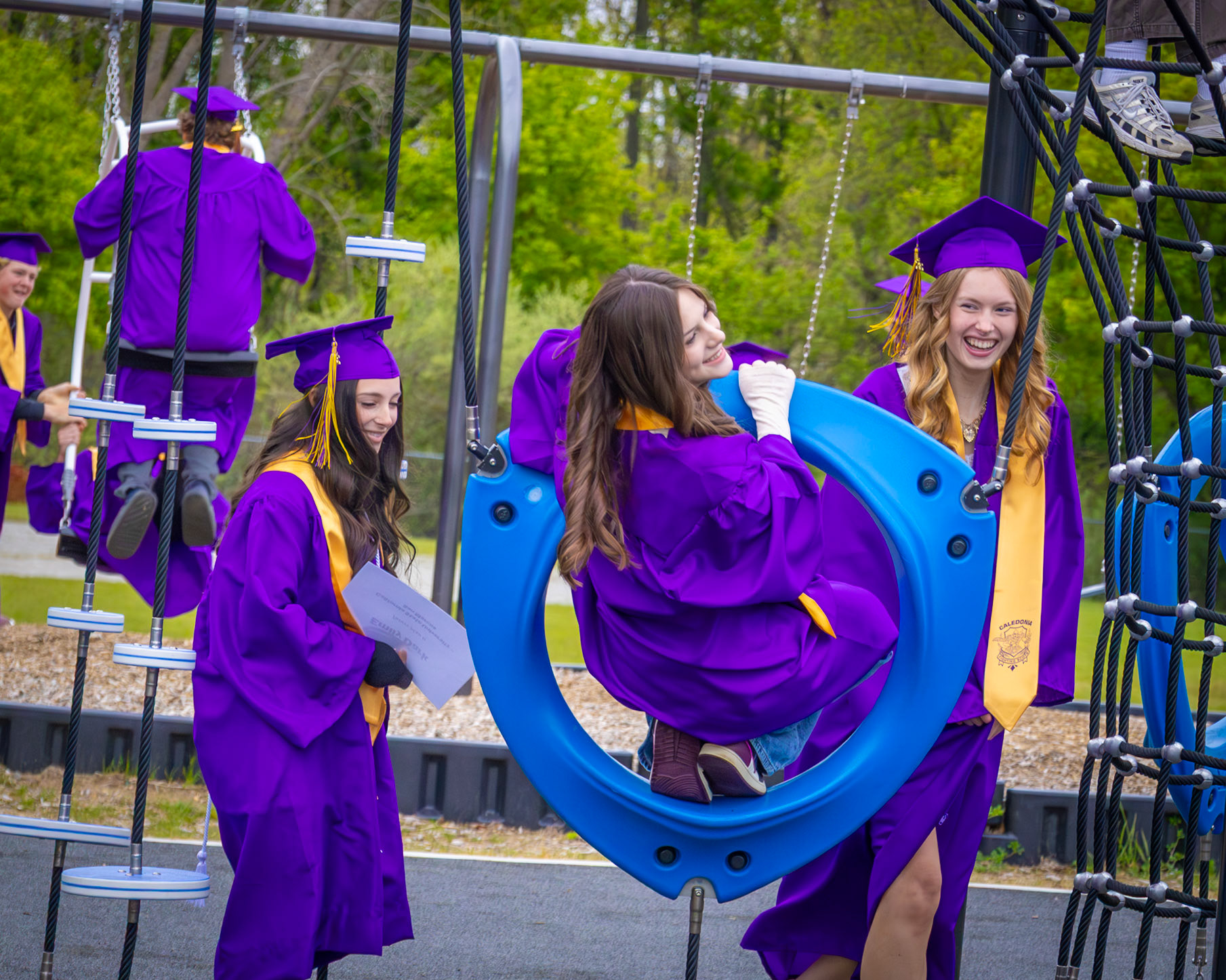 Emily Dark, Alexandra Aycock, and Hazel Horning enjoy one last time playing on their childhood playground before graduation. (Photo by Lilly Myers)