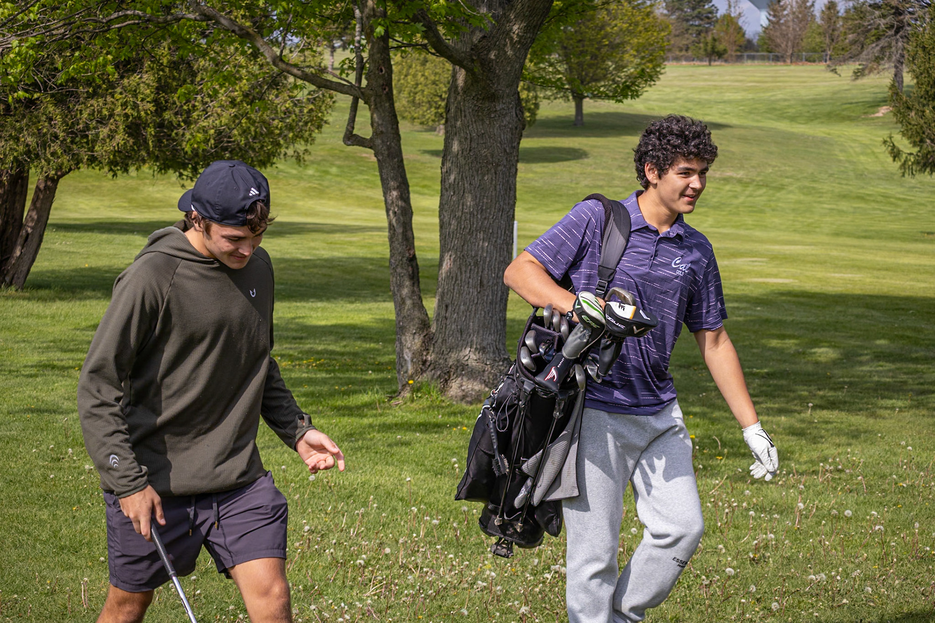 Connor Bloemers and Jackson Heffner catch up while walking back to the fairway. (Photo by Emma Garza)