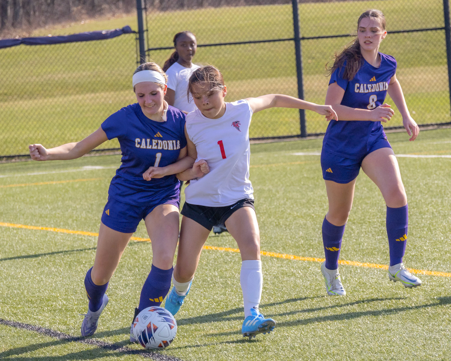 Ava Rigley fights off a defender and sends the ball back downfield. (Photo by Ella-Grace Wickens)
