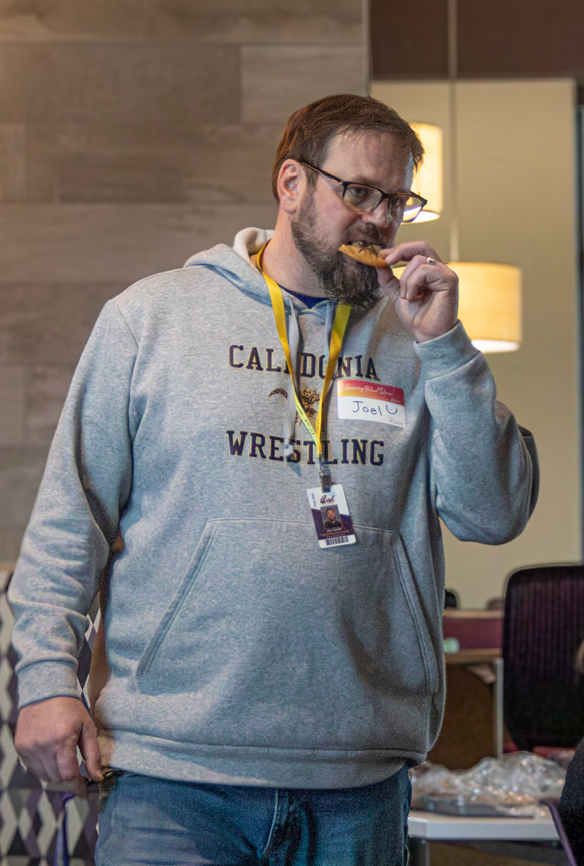 While waiting for his turn to donate blood, Mr. Reeder enjoys a chocolate chip cookie and takes a moment to relax during the school blood drive. (Photo by Brianna Severson)