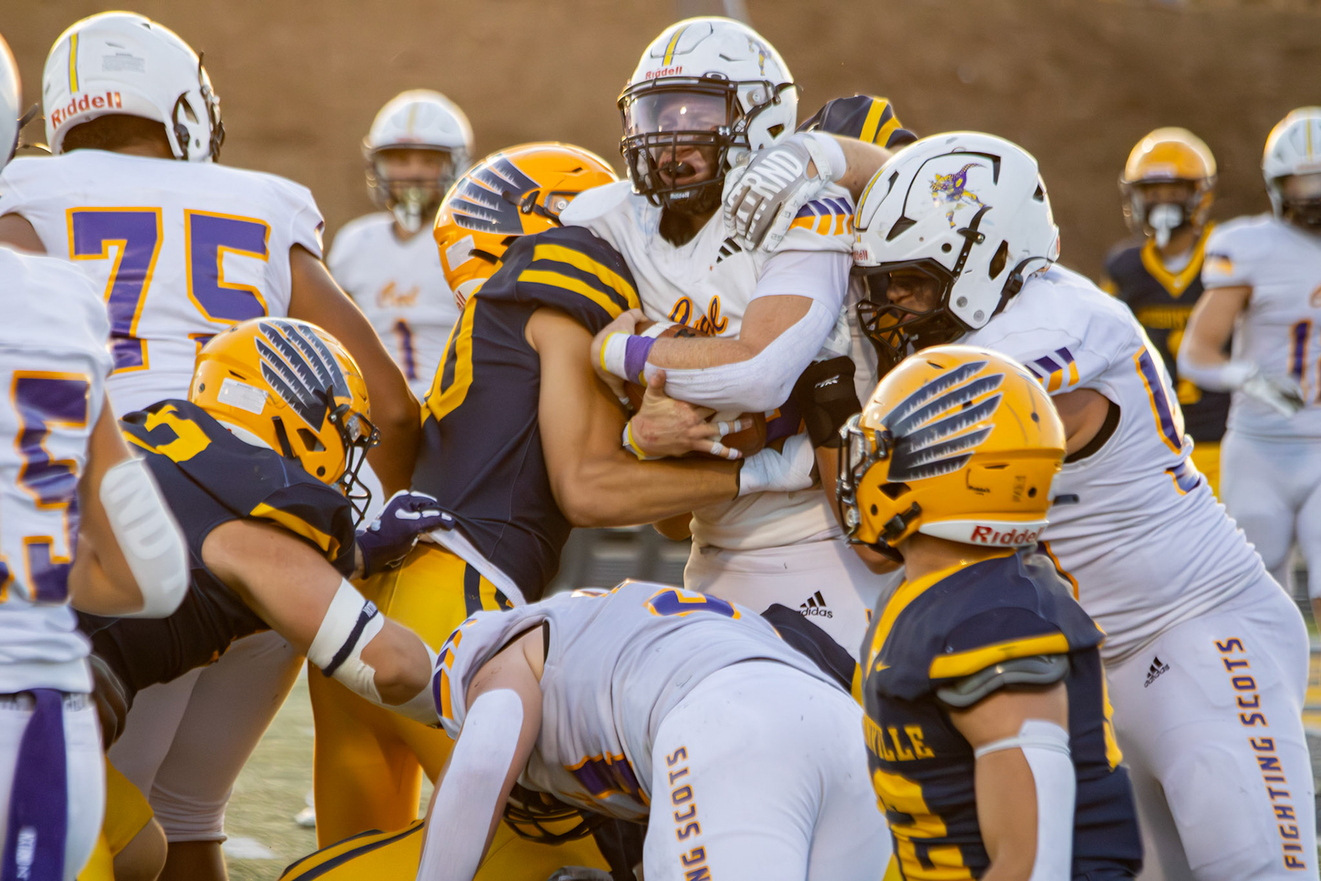 Ryne Wysocki battles through the Hudsonville defense, trying to break free  (Photo by Taya Penoes)