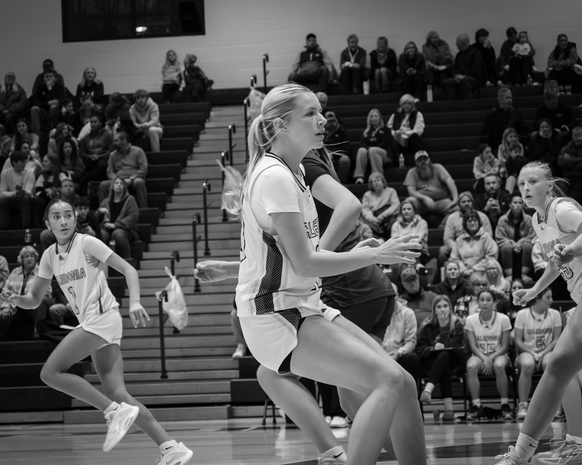 Dominating the court in the first game of their seasion, Braylee Tep, Laney Winstrom, and Ellie Radel pursue the ball down the court. (Photo by Abigail Tava)
