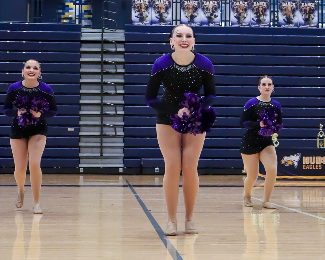 Jaycie Duffy, Evelyn Hargreaves, and Katie Johnson smile at the crowd while performing their Pom routine, "I Love Me!" (Photo by Jaylah Naves)
