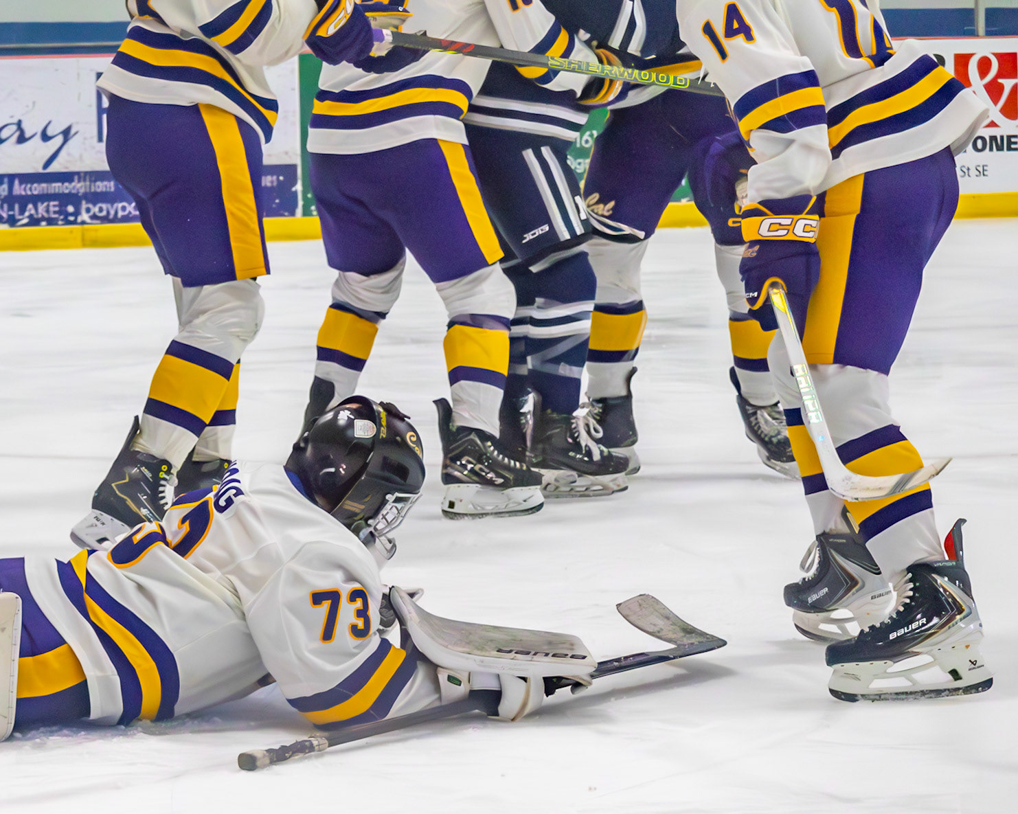 After scrambling to cover the puck, senior Sam Hoag ends up on his stomach as teammates quarrel with a Marysville player. (Photo by Avarey Lippert)