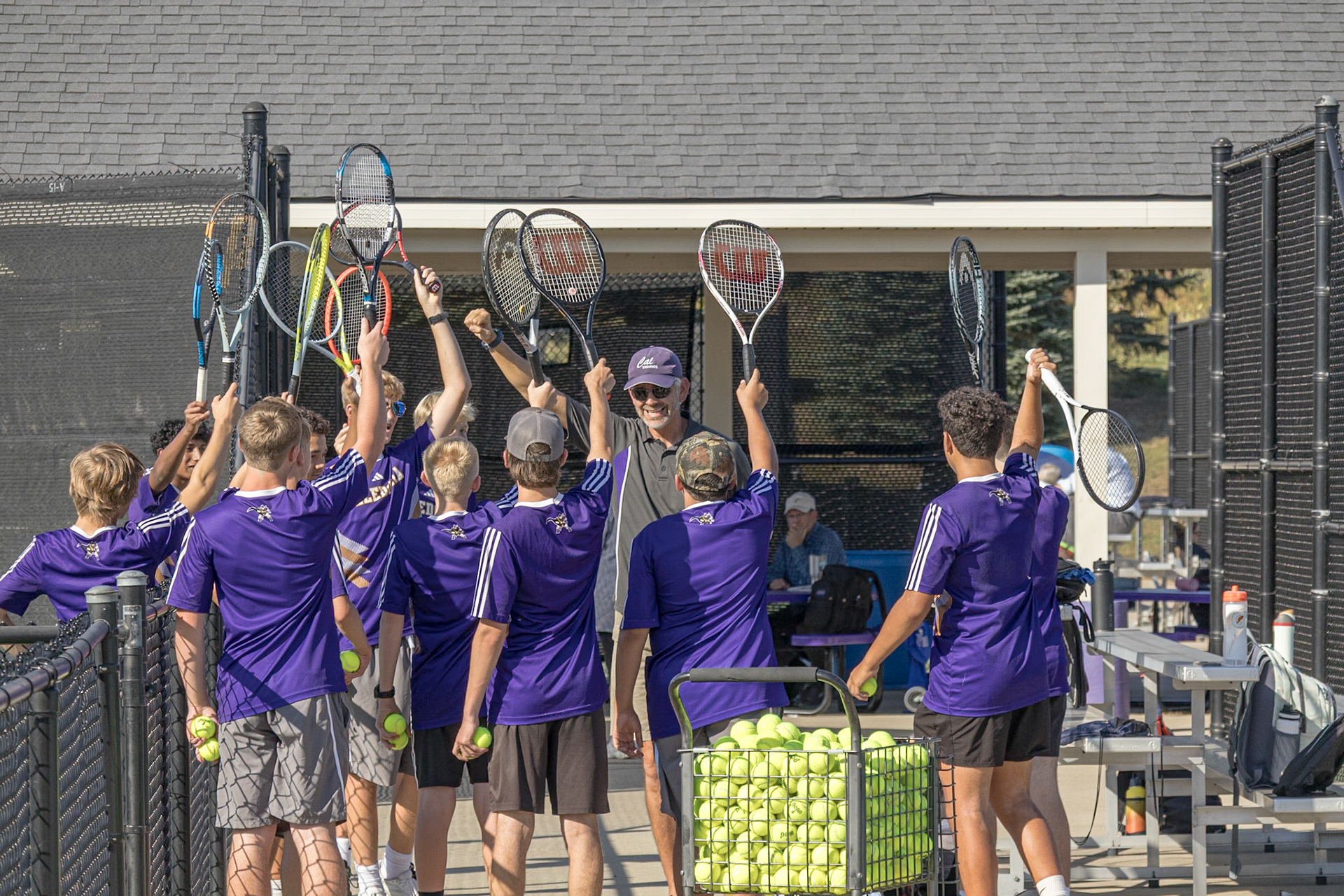 READY TO RALLY  Rackets in hand, the team gears up for a focused match. (Photo by Justin Harper)