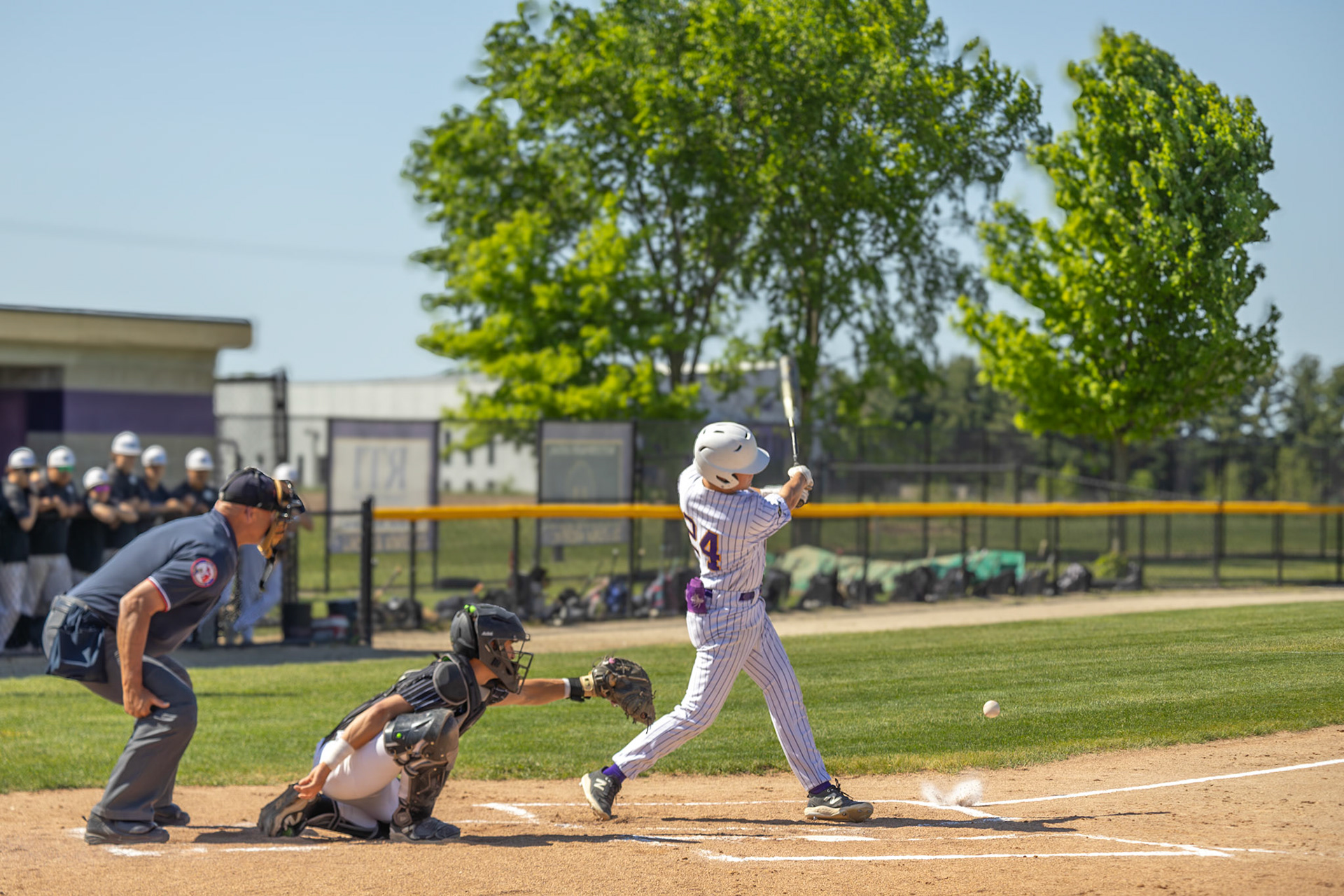 With the game on the line, Carter Berends delivers a powerful swing against West Ottawa. (Photo by Kaydence Kammer)