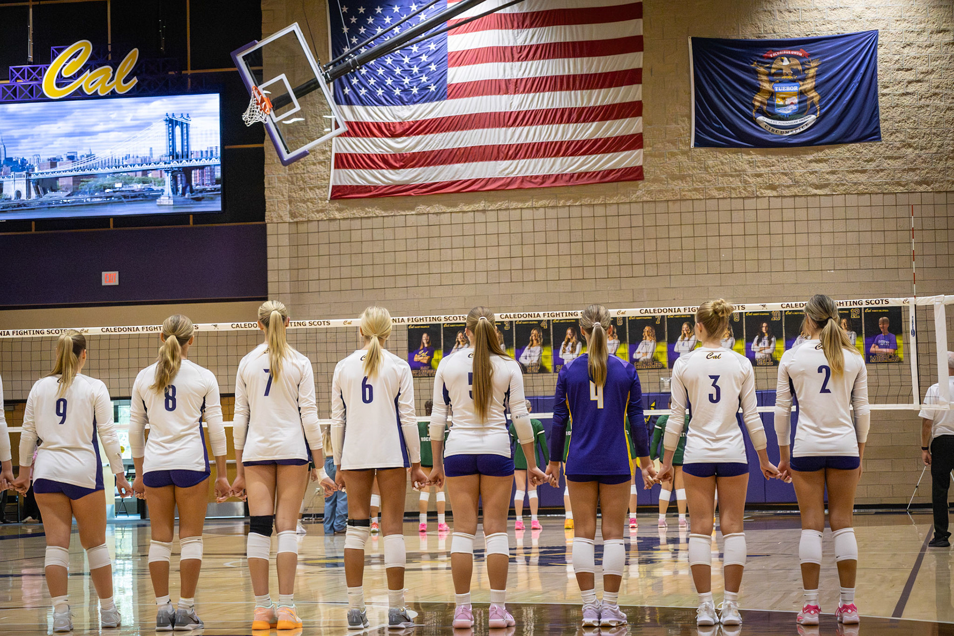 Varsity Volleyball linked together by pride and determination, mentally preparing for the game ahead. (Photo by Khloe Lowande)
