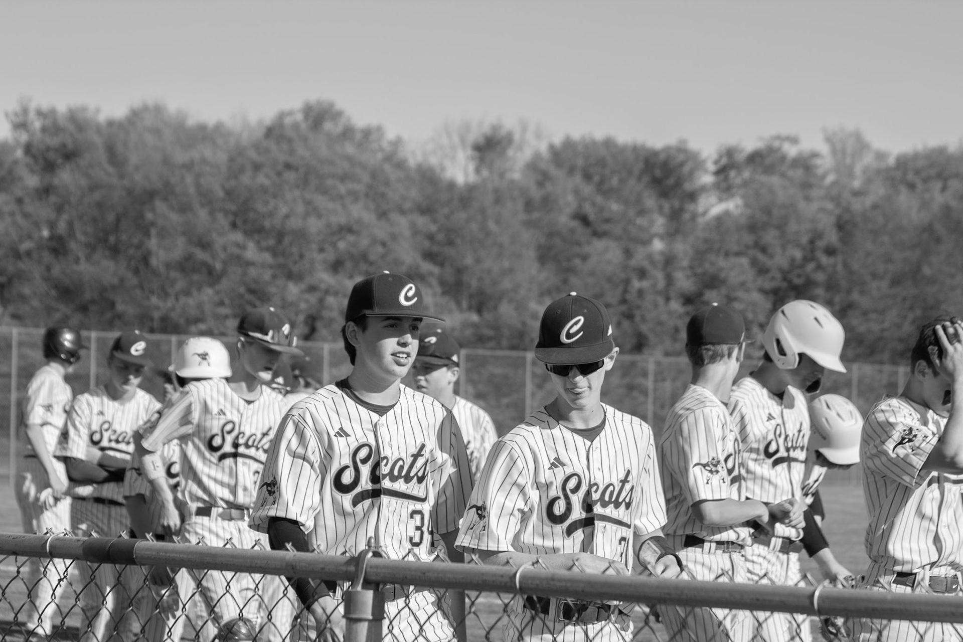 The freshman squad gathers around its coach, listening closely and sharing laughs while reflecting on the hard-fought game. (Photo by Elsha Bytwork)