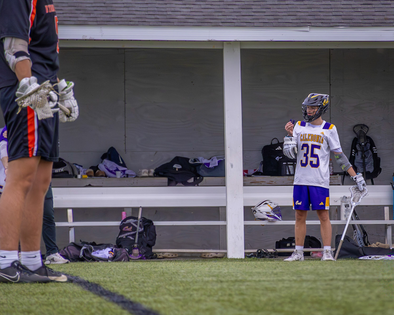 Cade Paalman considers his mouth guard. (Photo by Owen Zvonar)