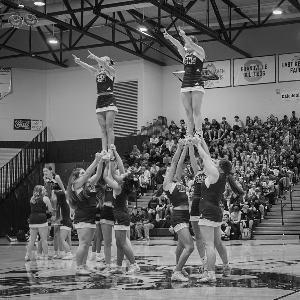 The cheerleaders lift school spirit as flyers Mariah Peterson and Alyssa Jernigan soar during the pep assembly. (Photo by Aslyn Crocker)