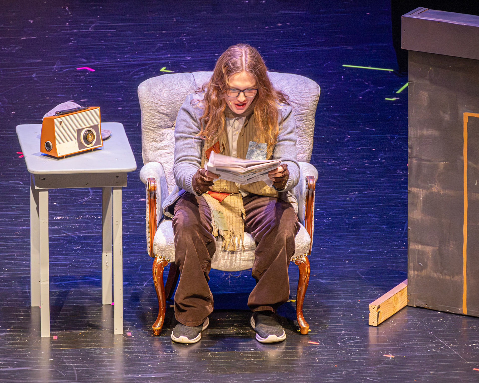 Charlie’s dad, played by Owen Williams, caught mid-read, eyes wide as the news of the Golden Tickets changes everything.(Photo by Mackenzie Popma)