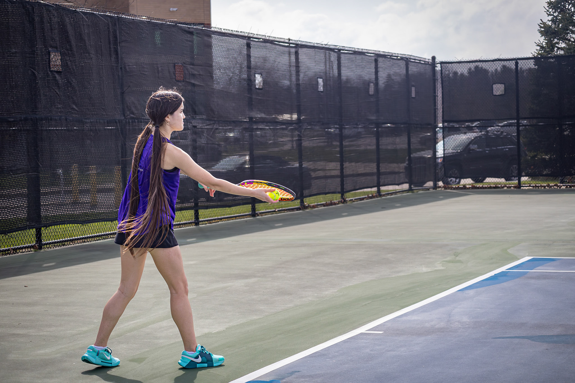 During warmups, Audrey Duong prepares to serve against a Mona Shores opponent, studying her rival’s technique to gain an early advantage. (Photo by Abby Skibinski)