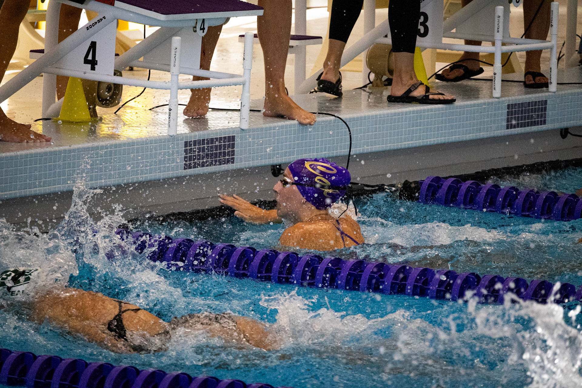Mya VanderZwaag powers through to touch the wall first. (Photo by Lena Gesing)