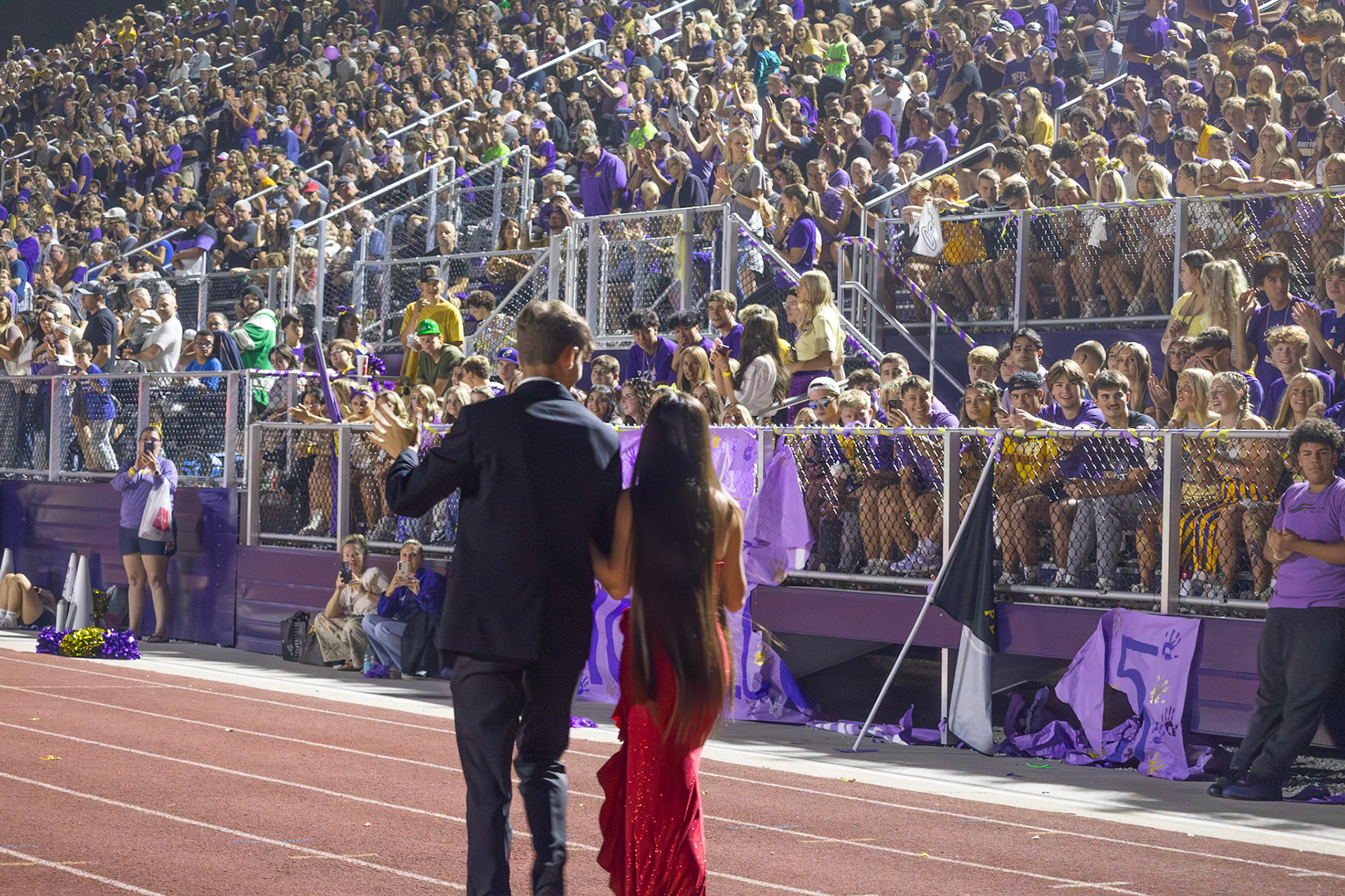 Audrey Duong and Isaac Robotham walk in front of the student section representing band. (Photo by Milana Rico)