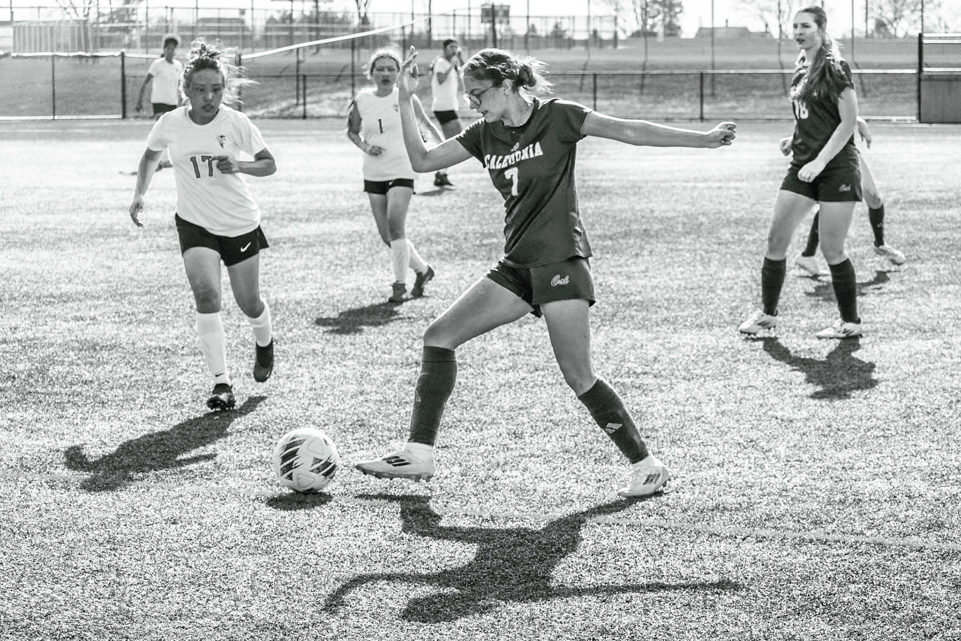 Raelynn TenElshof dribbles along the sideline, maneuvering around defenders and pushing the ball upfield. (Photo by Ella-Grace Wickens)