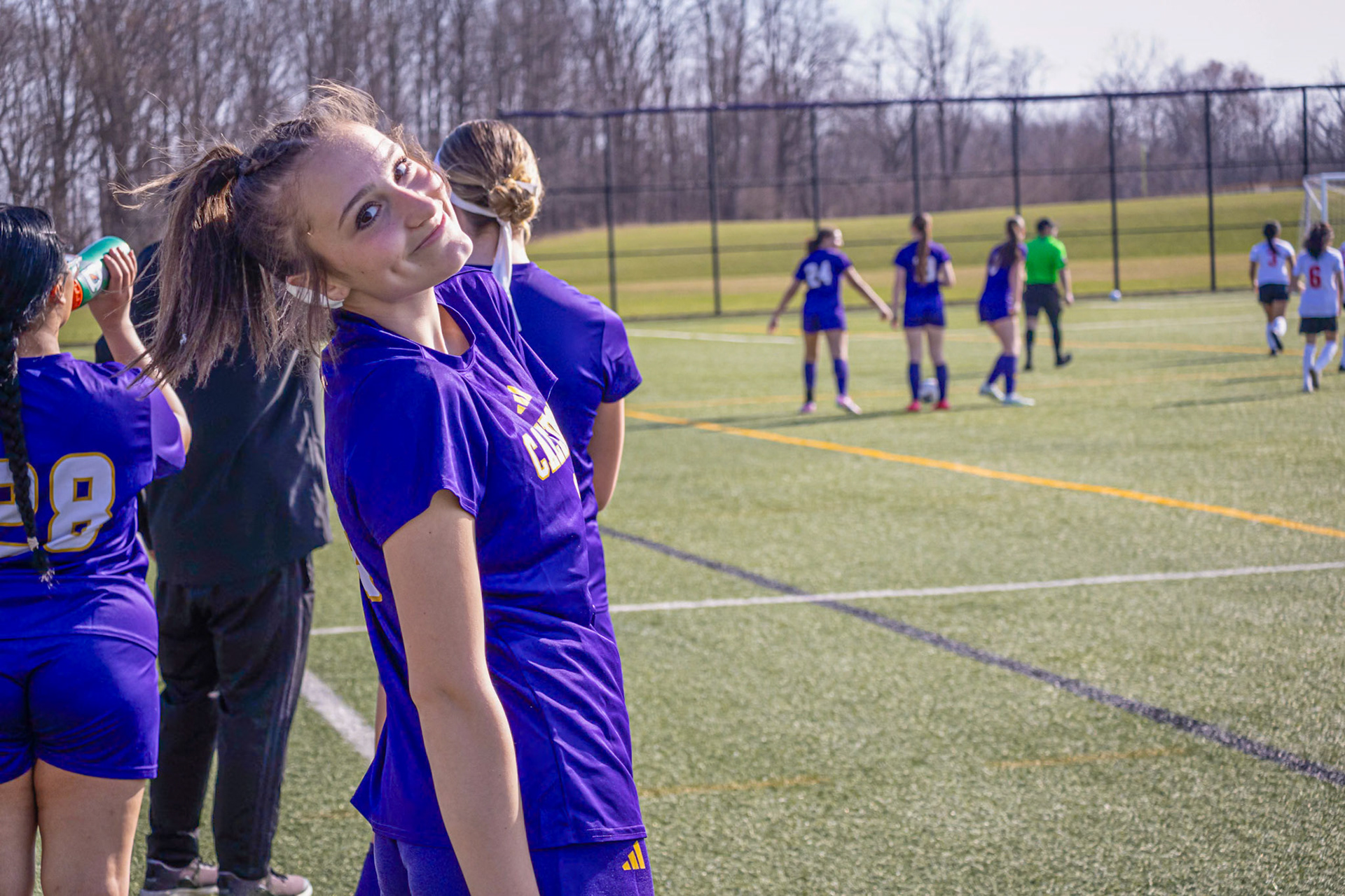 Maci Warburton smiles on the sidelines after coming off the field. (Photo by Ella-Grace Wickens)