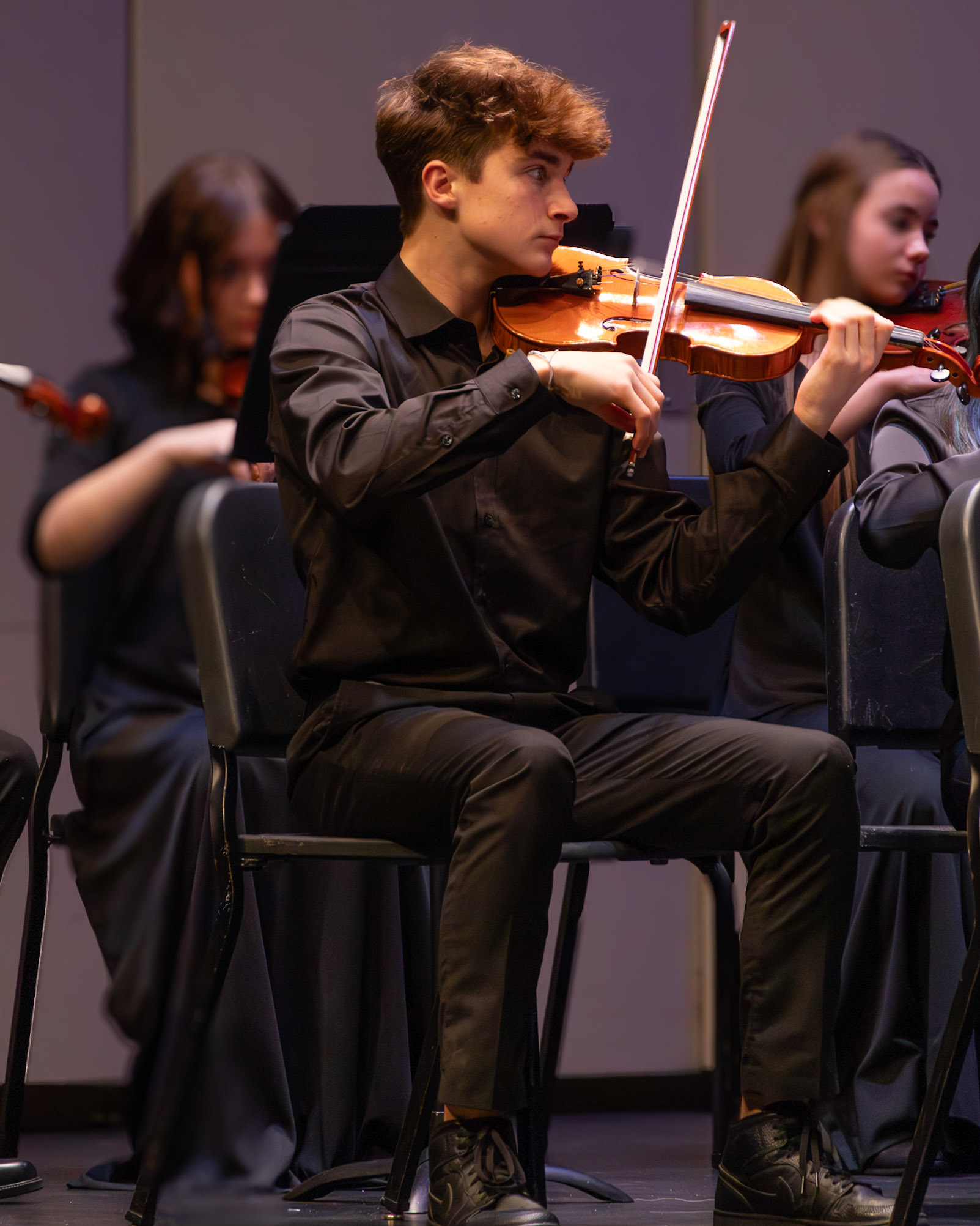 Sophomore Bennett Snapper plays his part during the orchestra concert.(Photo by Ollie Fox)