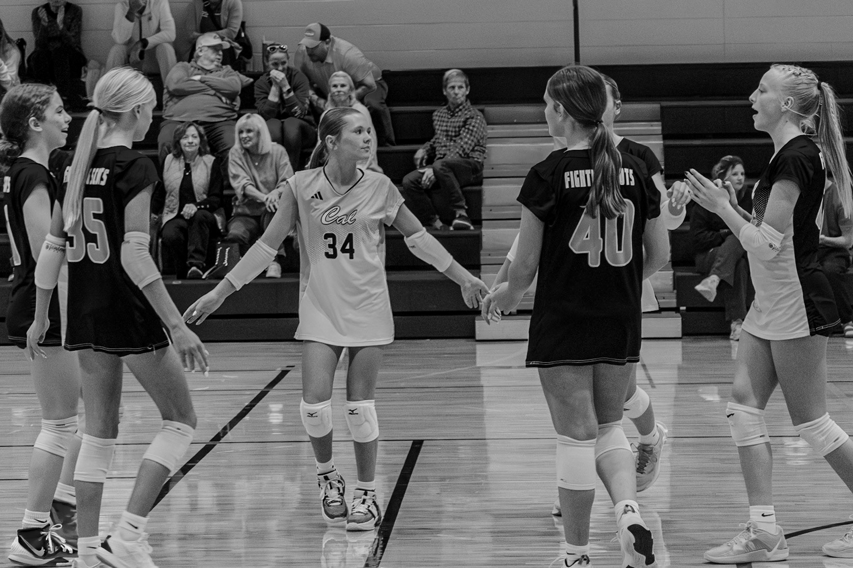 As the libero, Sophia Blaser scores a key point, and the team rallies around her, building momentum for repeated successes. (Photo by Aslyn Crocker)