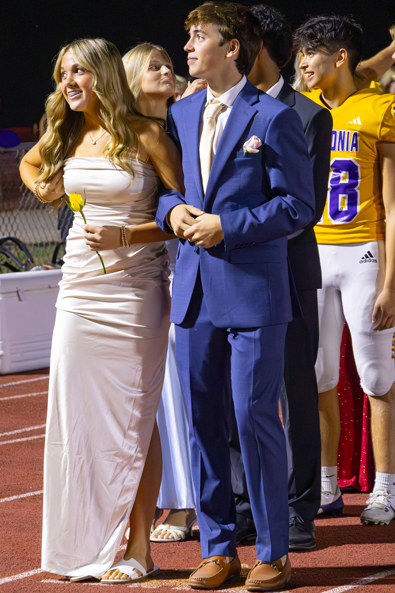 Ruby and Kaleb wait to walk down the track representing the freshman Homecoming Court. (Photo by Taya Penoes)