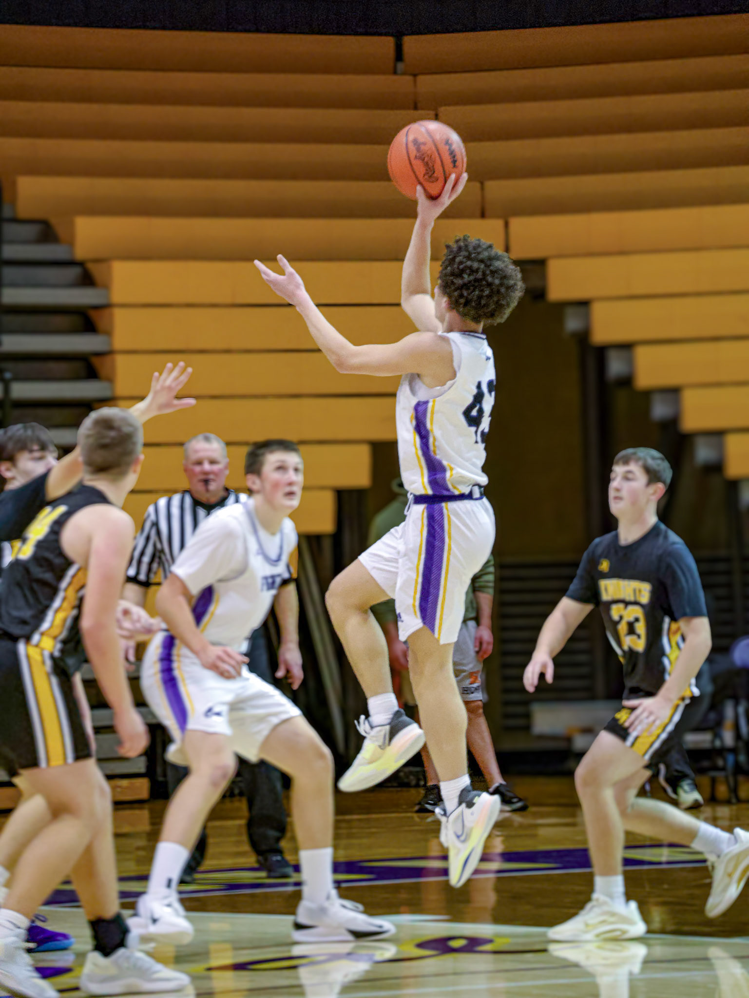 With confidence and focus, Levell Dunn moves through the defense, ball in one hand, aiming for the perfect shot. (Photo by Mackenzie Popma)
