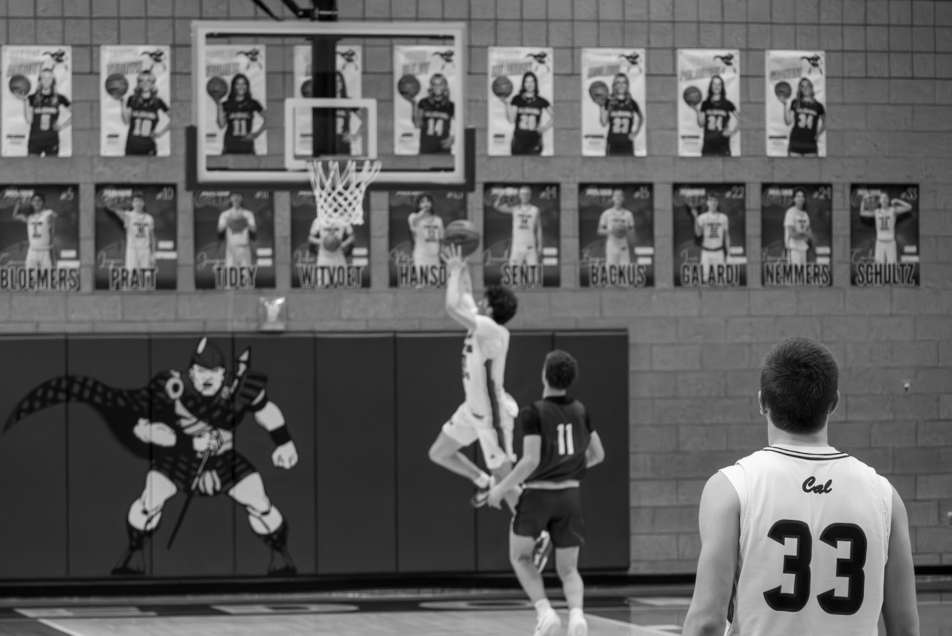 Conlan Schultz admires teamate Logan Pratt as he steals the ball and heads down court for a contested layup. (Photo by Thomas Fryers, Jr.)